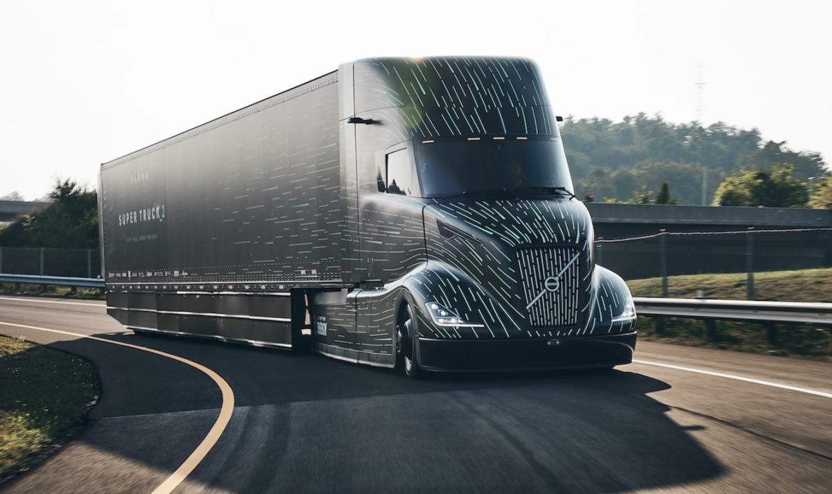 Aerodynamic semi-truck with optimized design traveling on a highway during sunset.  