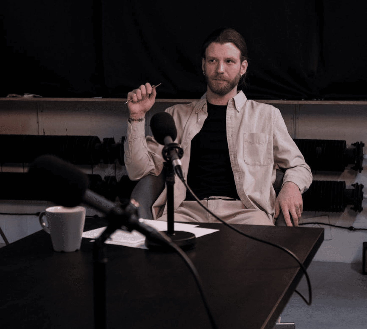 a guy filming in a podcast studio
