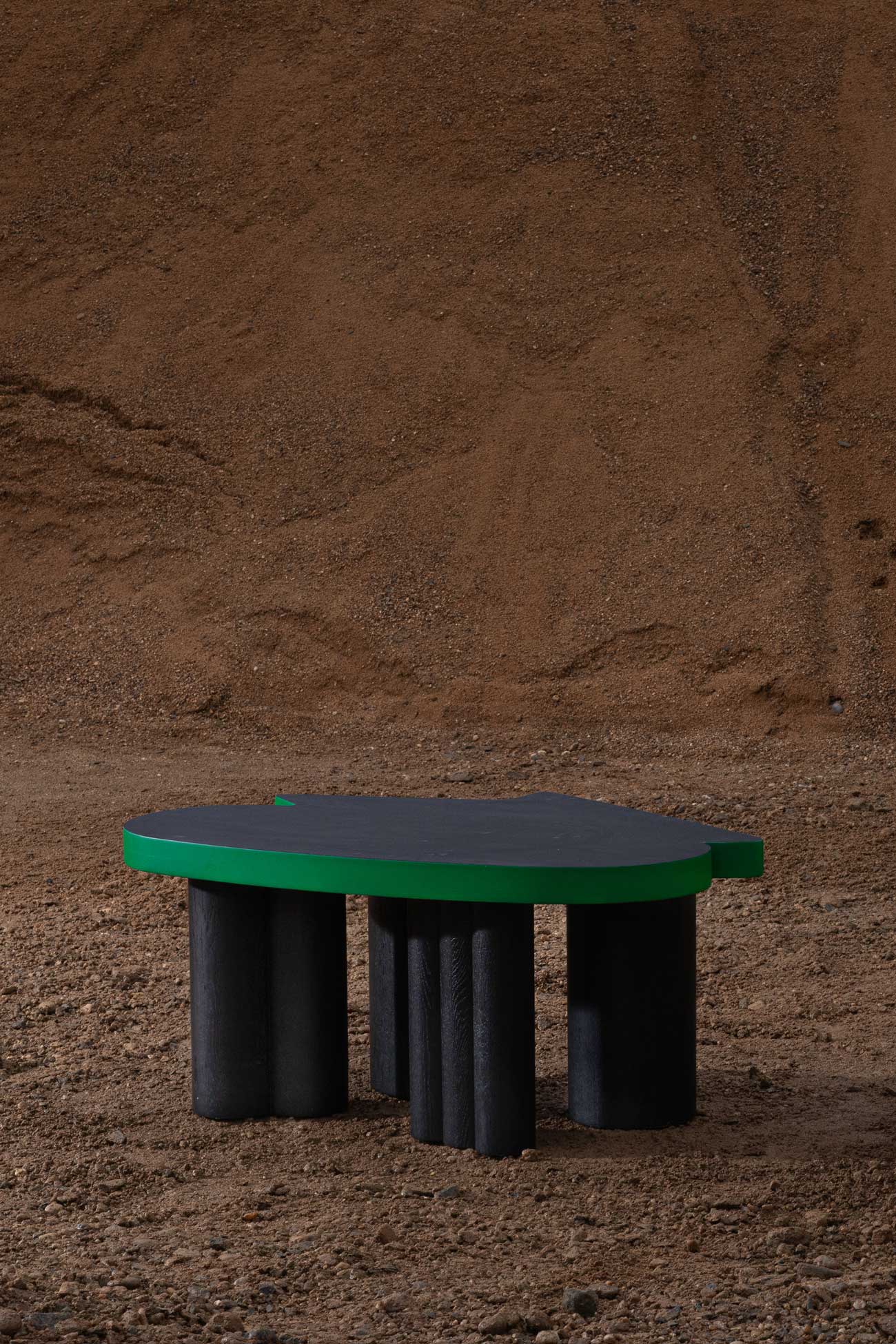Cloudy impromptu noir low wood table in black and green with bold geometric top and legs by Jiri Krejcirik