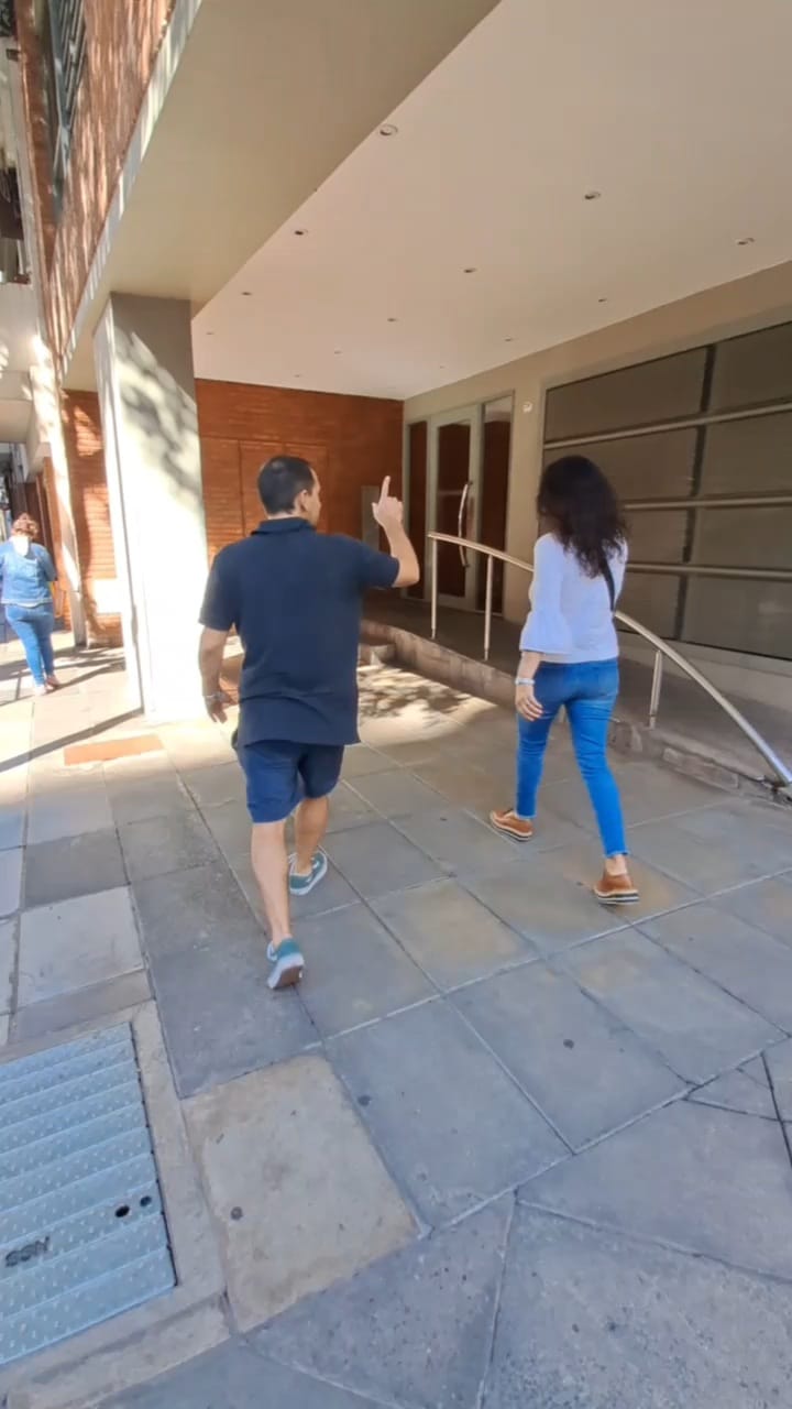 a group of people standing on the side of a building