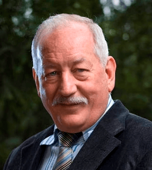 Older man with a mustache in a dark gray suit