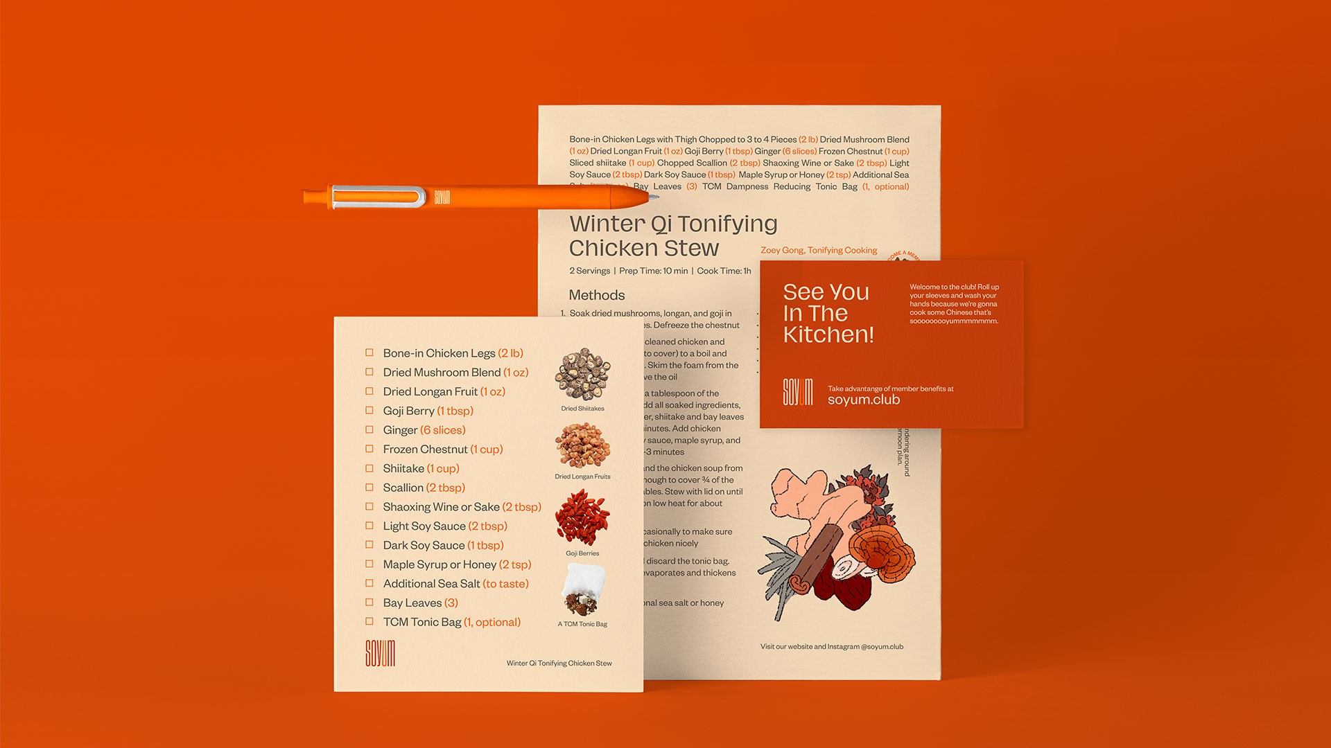 A winter stew recipe card displays ingredients and instructions: Bone-in Chicken Legs Legs (2 lbs), Dried Longan Fruit (1 oz), Goji Berry (1 tbsp), Ginger (1 tbsp), Frozen Chestnut (1 cup), Shiitake (1 tbsp), Scallion (2 tbsp), Shaoxing (2 tbsp), Light Sauce (2 tbsp), Dark Soy Sauce (1 tbsp), Maple Syrup or Honey (2 tbsp), Bay Leaves (3 tbsp), TCM Tonic Bag (1 tbsp), Bone-in Chicken Legs Thighs with Chopped to 1/4 Pieces (2), Dried Mushroom Blend (1 oz), Goji Berry (1 tbsp), Ginger (2 tbsp), Shredded Chicken (1 tbsp), Dried Longan Fruit (1 tbsp), Goji Berry (1 tbsp), Ginger (1 tbsp), Frozen Chestnut (1 cup), Shiitake (1 tbsp), Scallion (2 tbsp), Shaoxing (2 tbsp), Light Sauce (2 tbsp), Maple Syrup or Honey (2 tbsp), Bay Leaves (3 tbsp), TCM Tonic Bag (1 tbsp), Instructions: 2 servings (2 servings), Prep Time: 10 min, Cook Time: 10 min, Methods: 1. Steak dried mushrooms, Longan, and gogi in chicken and soy sauce (1 tbsp), Shred the chicken and onions, Add ginger, shiitake, bay leaves, and salt and pepper (1 tbsp), Add chicken and simmer for 3 minutes, Add the chicken soup, cover with 1/4 cup of water, and simmer for 5 minutes, Remove from heat, garnish with fresh herbs, serve with rice or noodles.<br><br>A separate card displays a cartoon illustration of a chef preparing food, with text: “See You In The Kitchen!” and “Take advantage of number benefits at soyum.club.” A pen rests on the card.