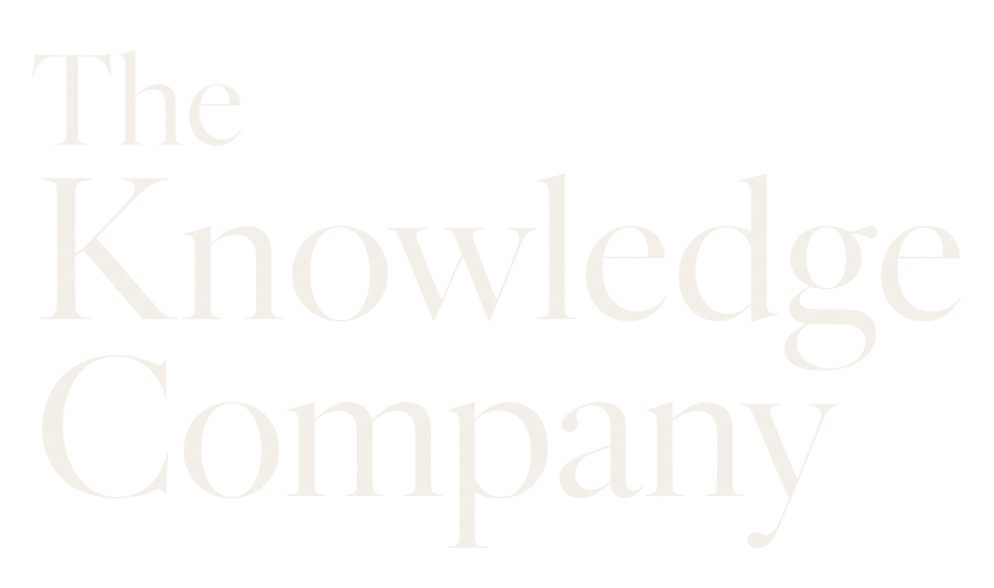 The Knowledge Company wordmark in parchment on ink