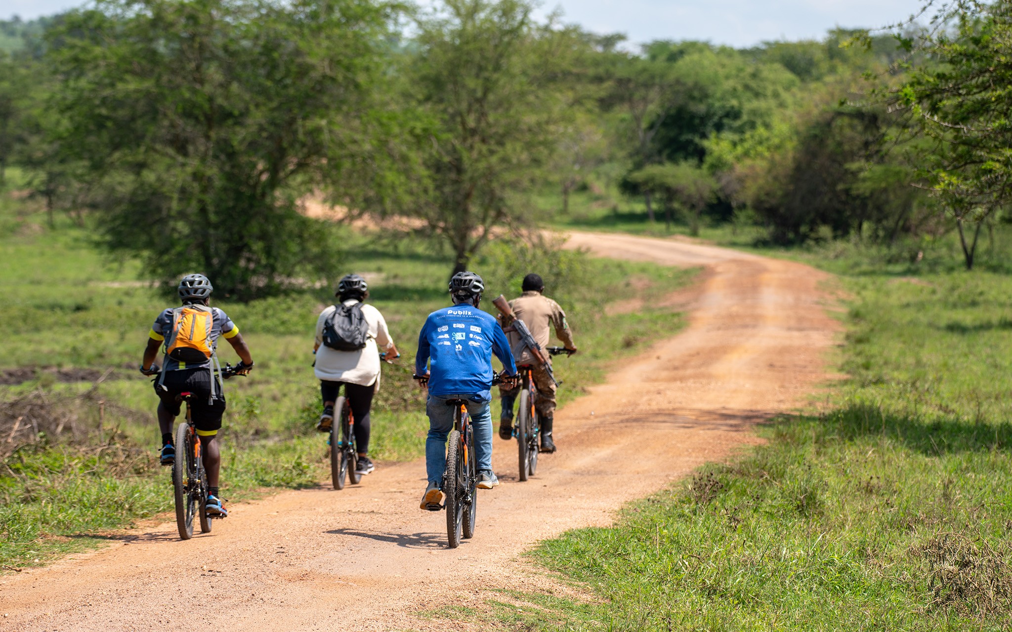 A ranger guides leads tourists on a cycling tour through Lake Mburo National Park