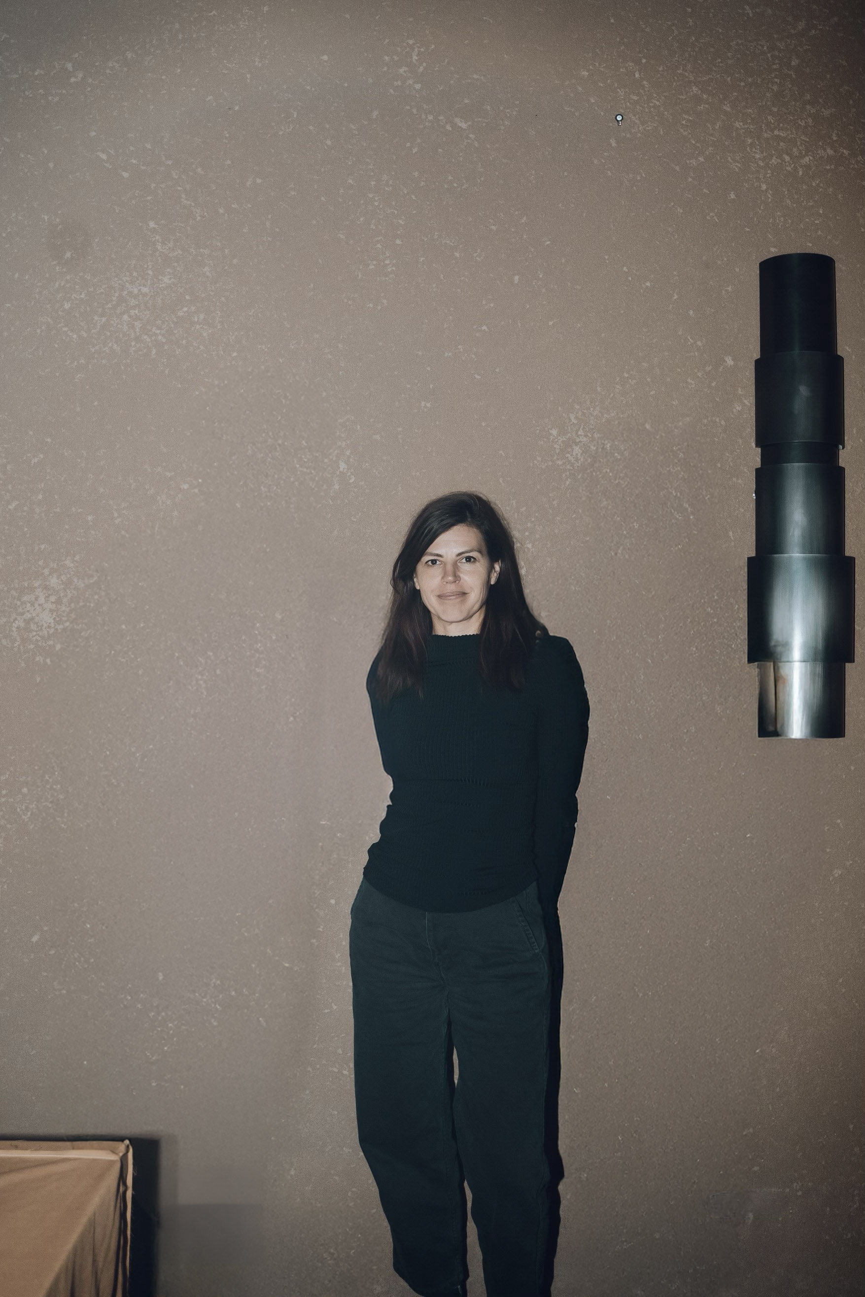 woman in black clothing in sparce room