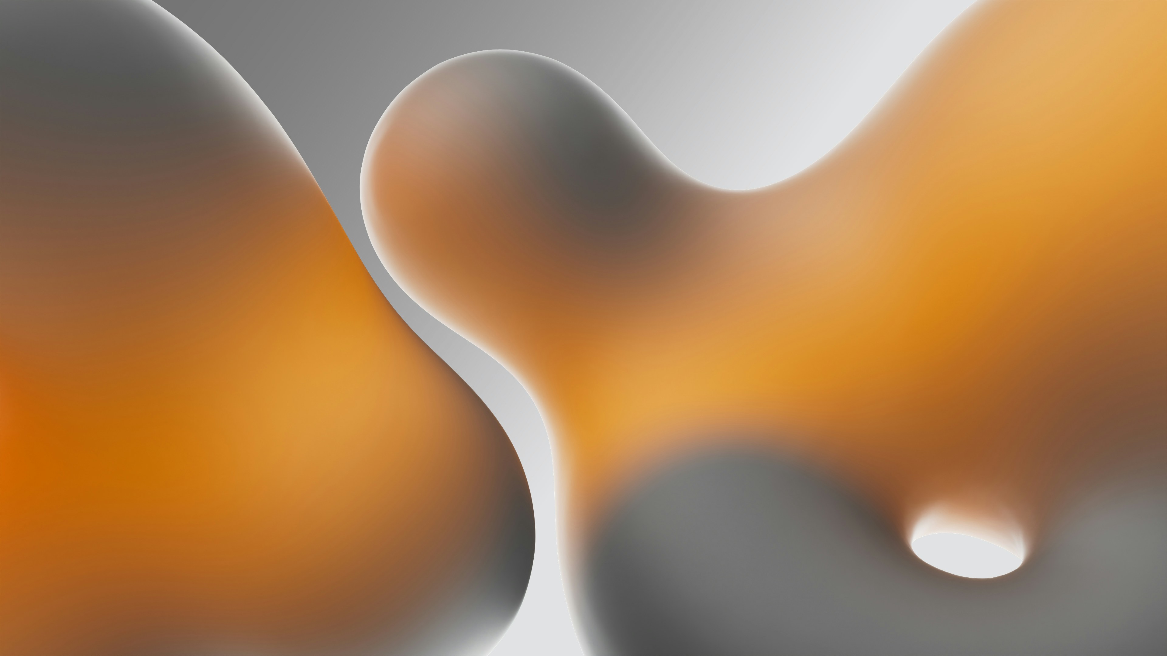 A winding road cuts through rocky terrain, surrounded by patches of green grass and illuminated by sunlight.