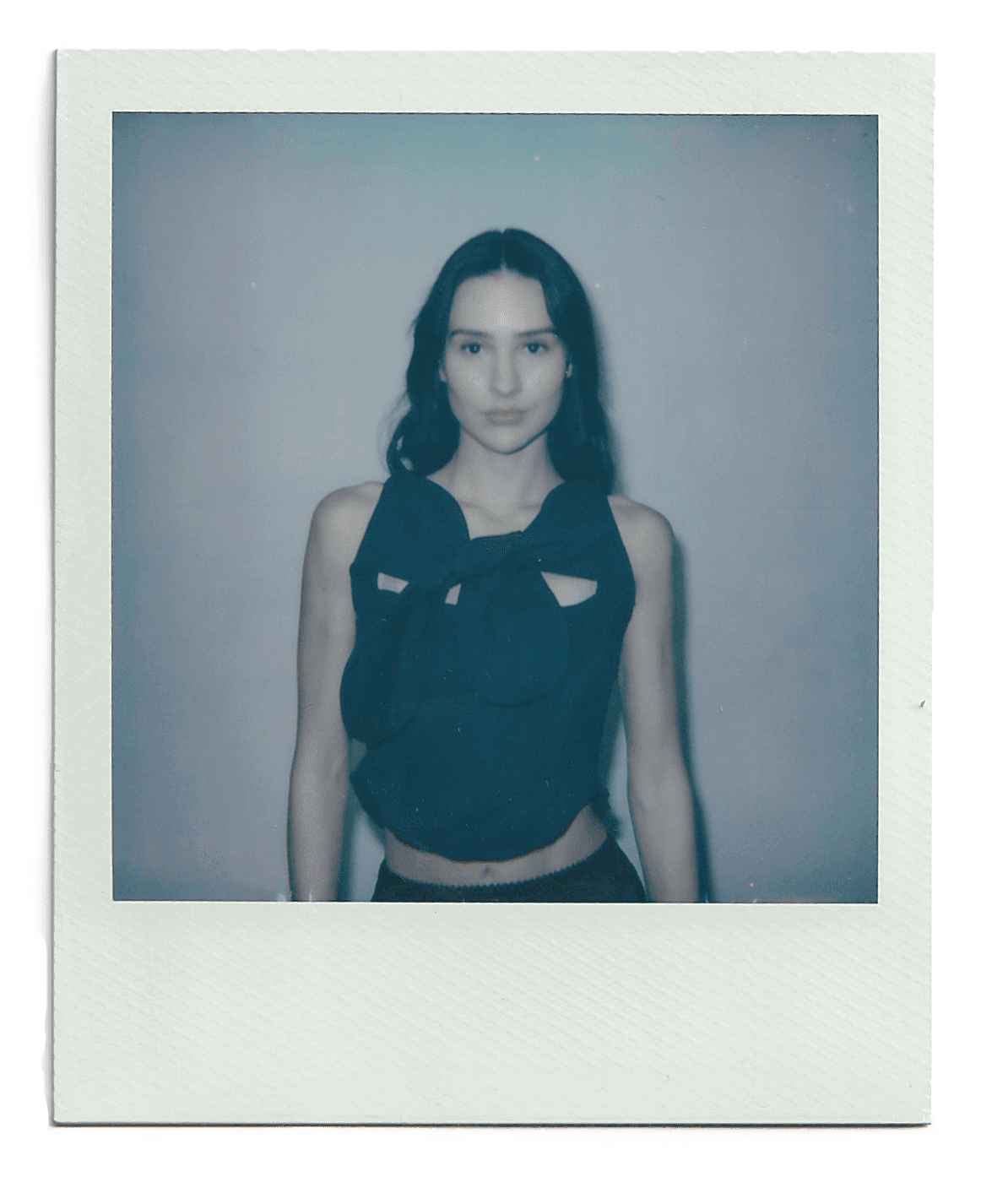 Young woman with dark hair and bangs, wearing red.