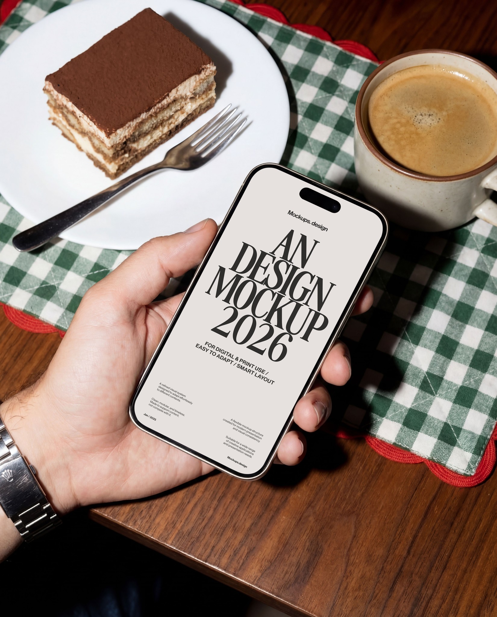 Hand holding iPhone 16 mockup at restaurant table