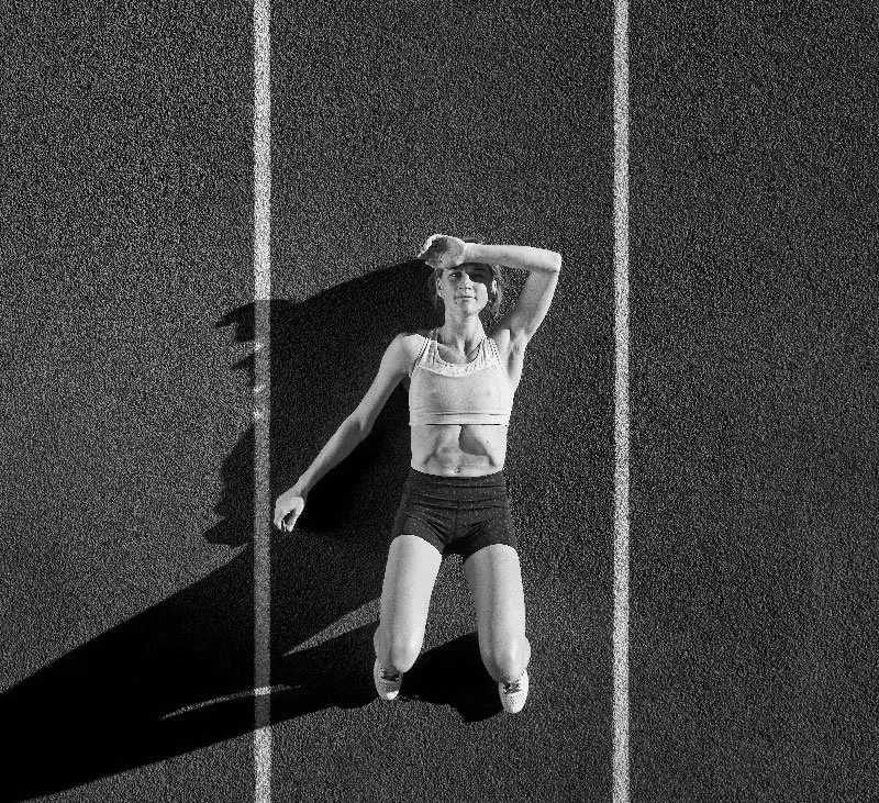 Lauren Fleshman, former professional track and field athlete, jumping on a running track