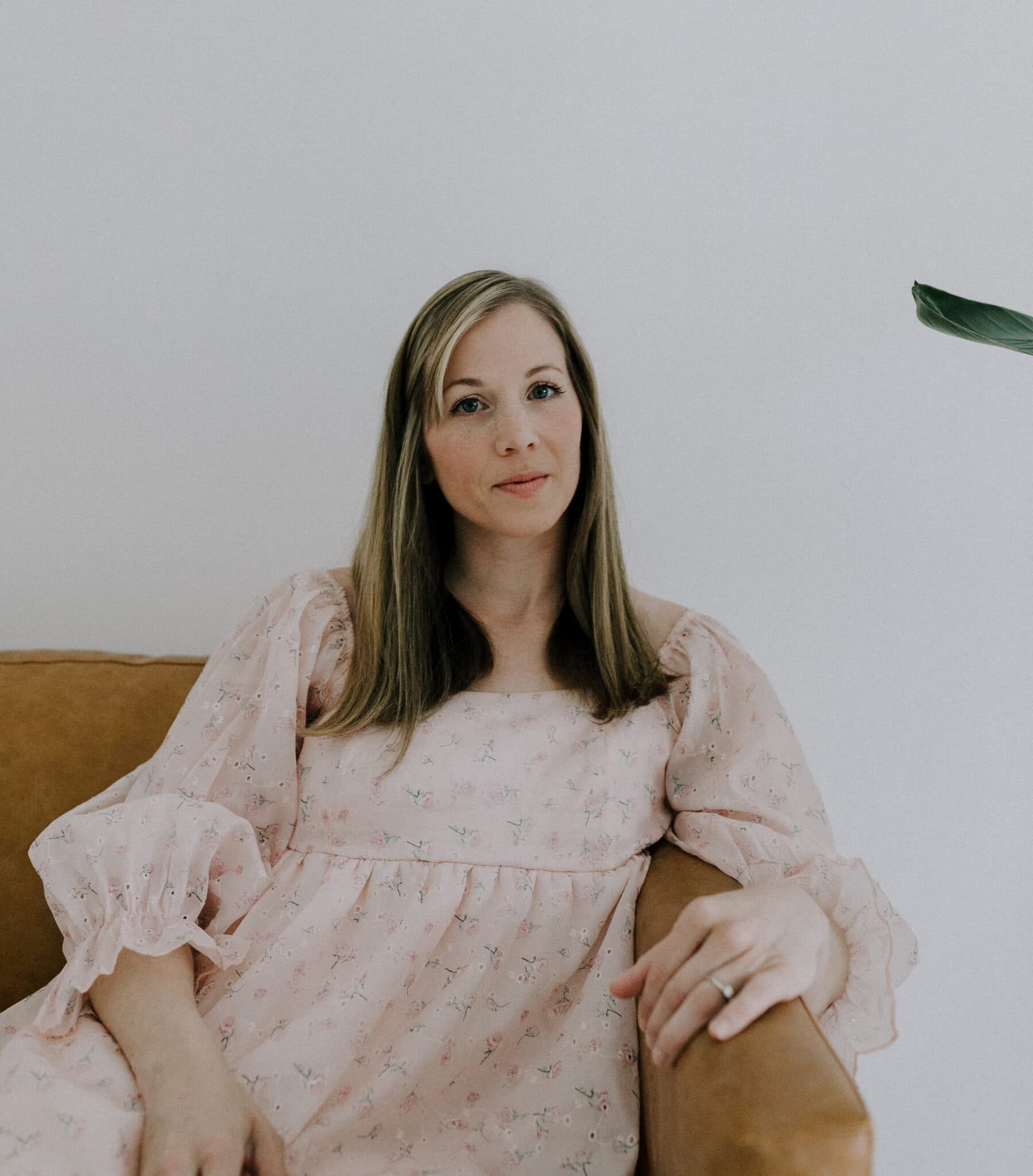 Sara McNeal sitting gracefully in a natural light setting at Revelator Studio, a premier photography studio in Shreveport, offering a serene and professional environment for creatives.