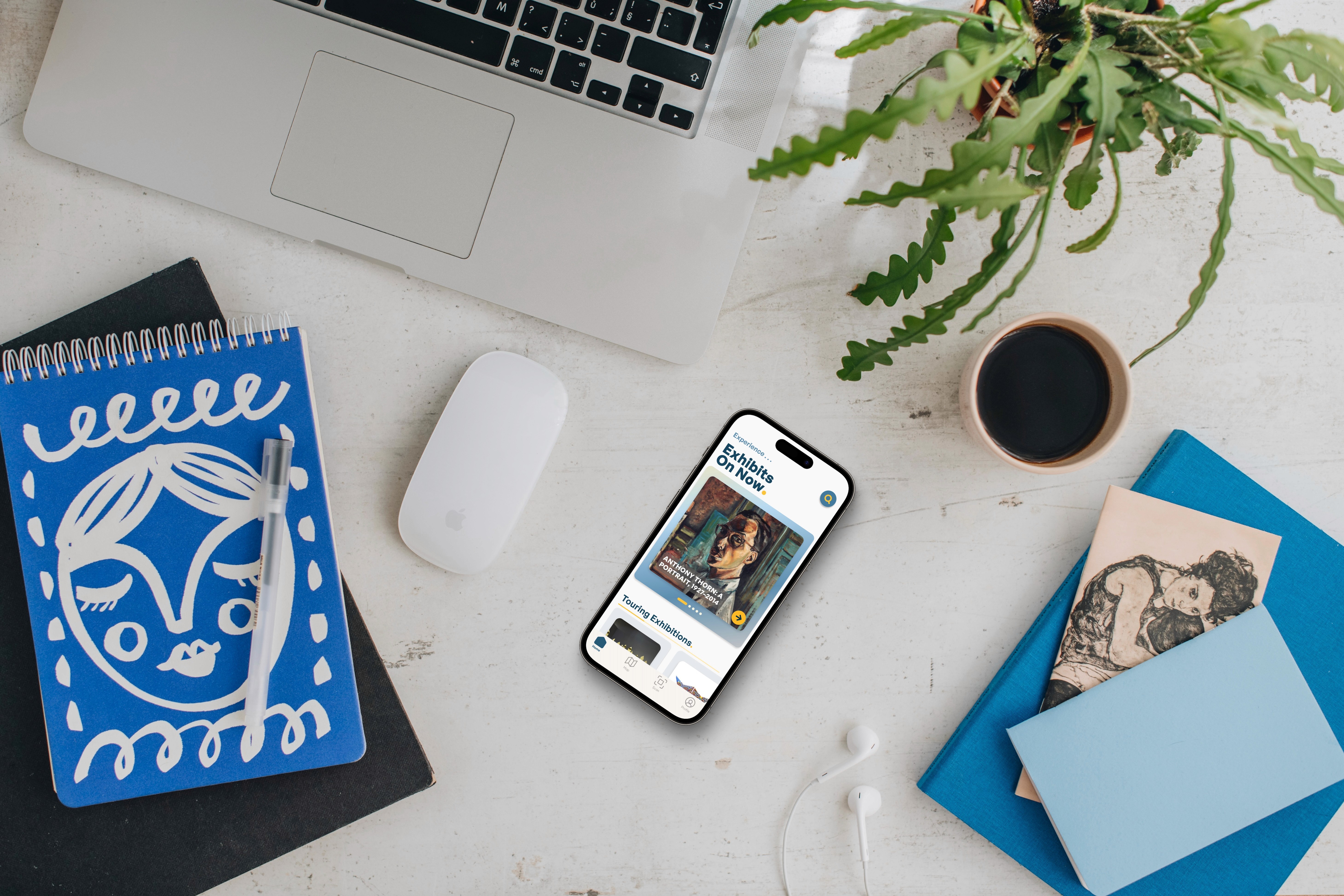 Mockup of Makenzie Art Gallery Guide App on Desk