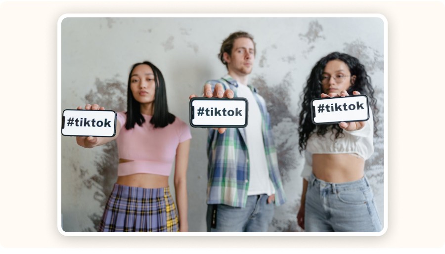 person holding phones with TikTok hashtag
