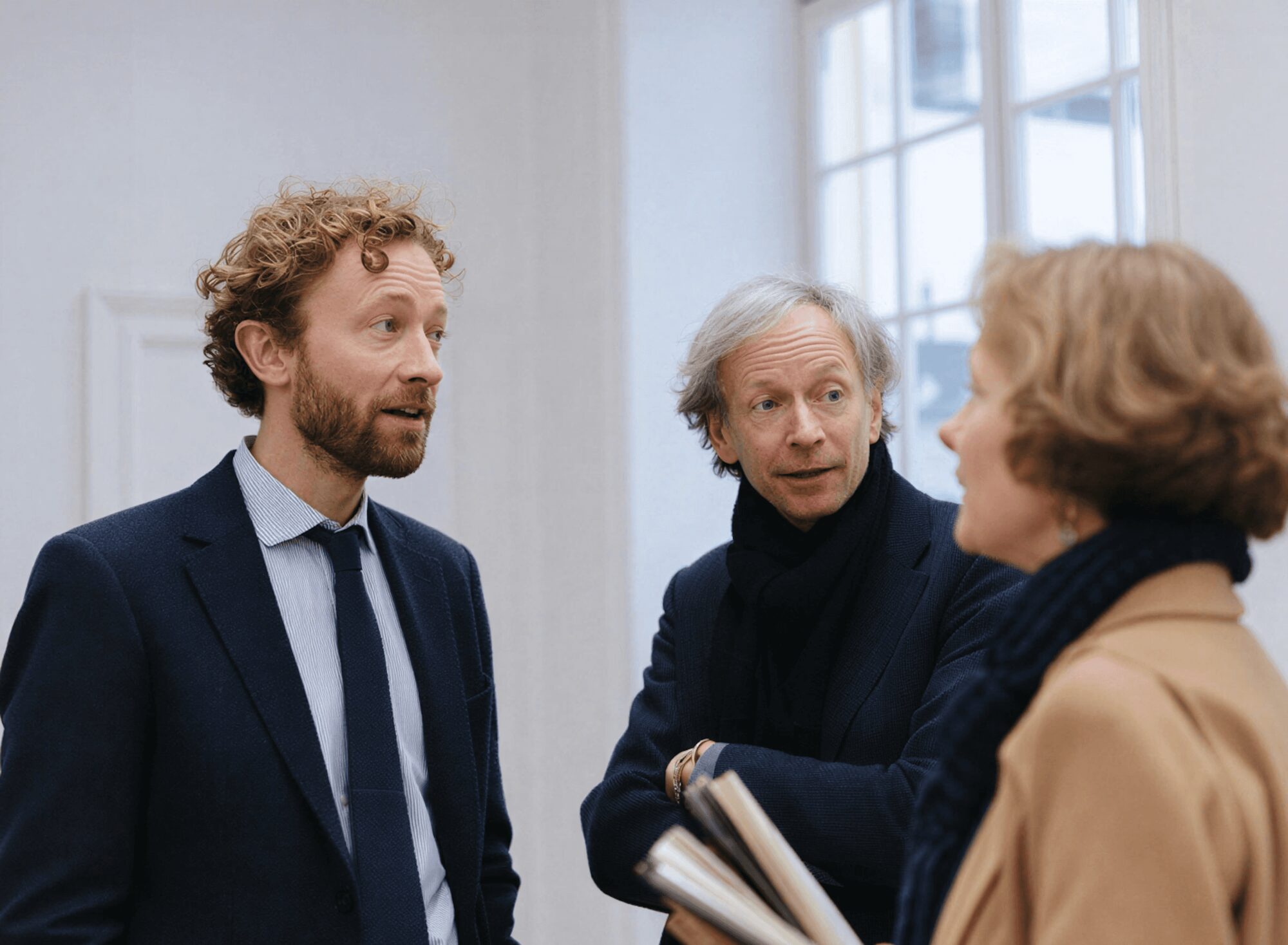 Three people talking in an office