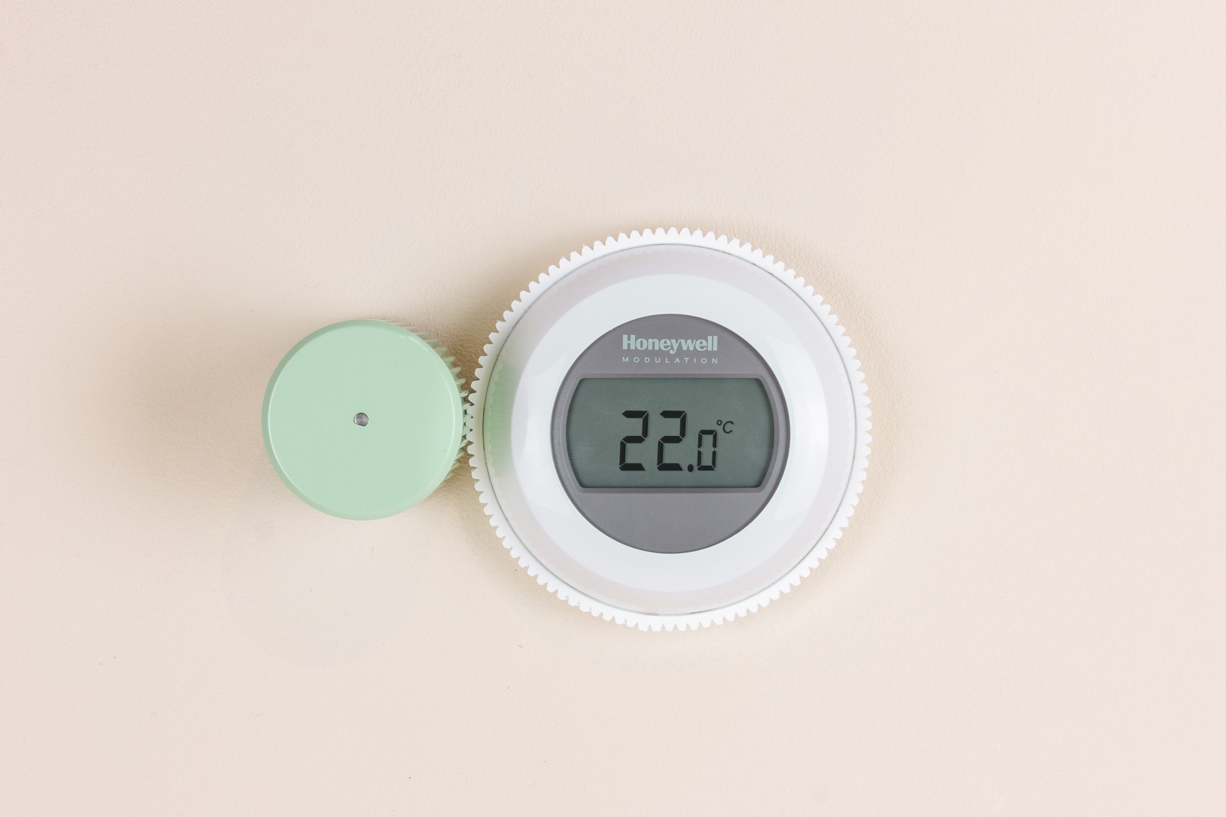 Image of a Smartian with the rotate add-on positioned next to a Honeywell thermostat