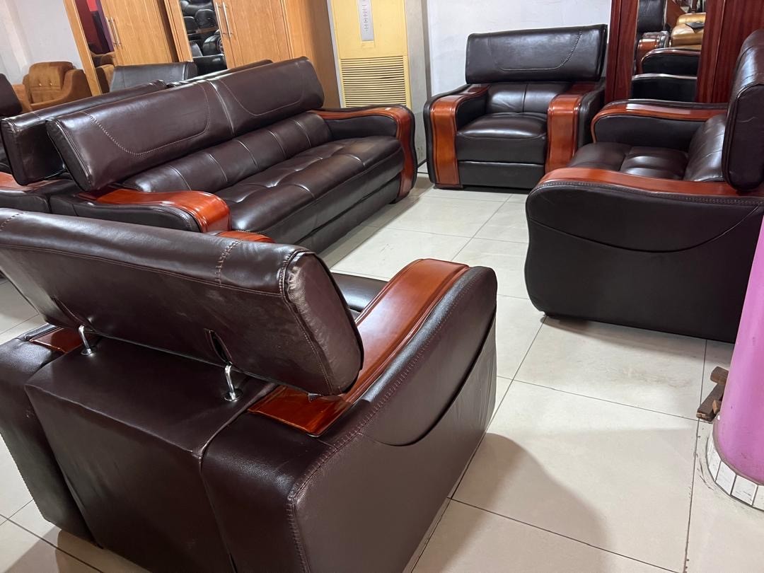 a gray couch with a wooden base on a gray background