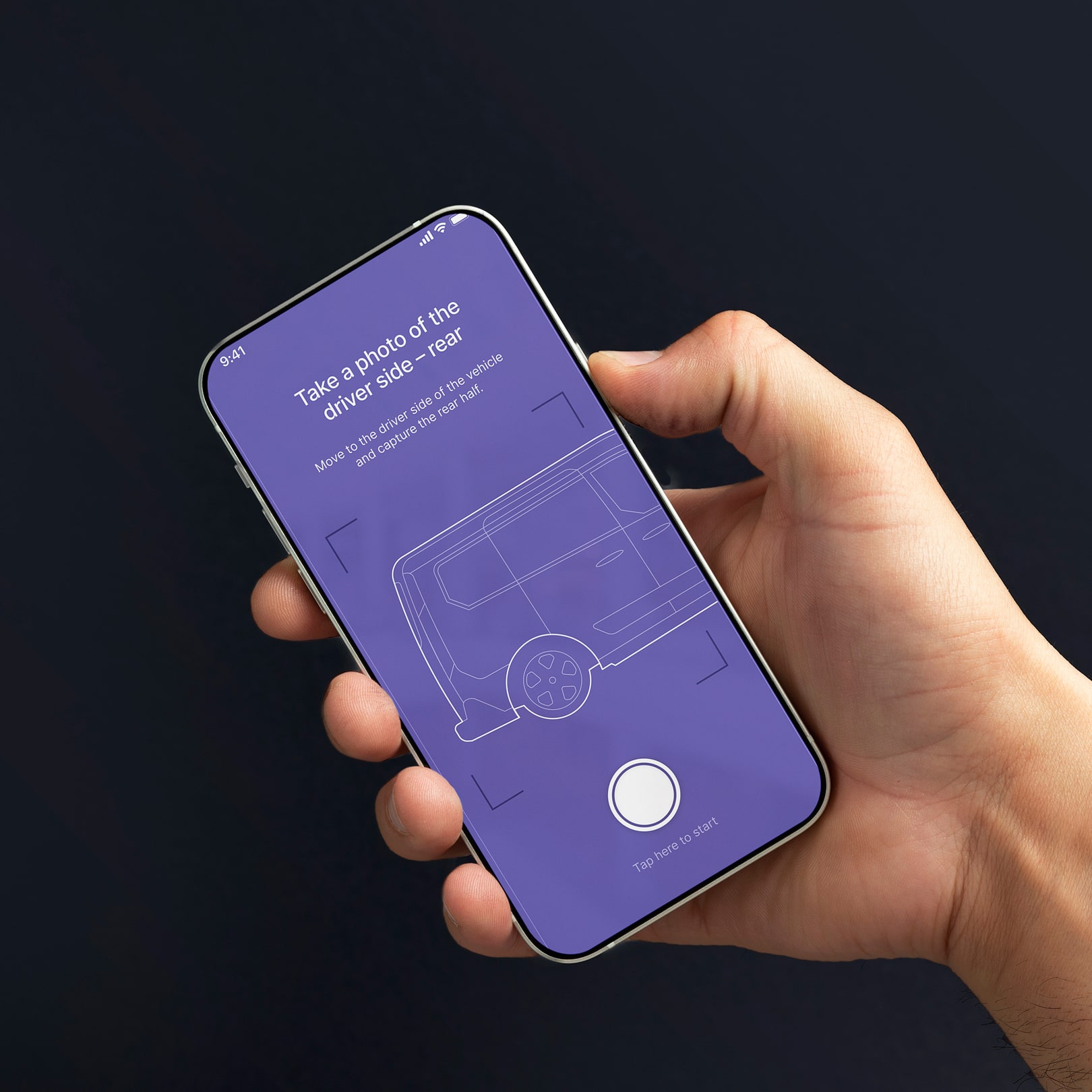 A hand holding an iPhone against a dark background showing the DamageCheck AR camera guidance screen in purple, prompting the user to photograph the driver side rear of a vehicle with a line-drawn diagram and shutter button.