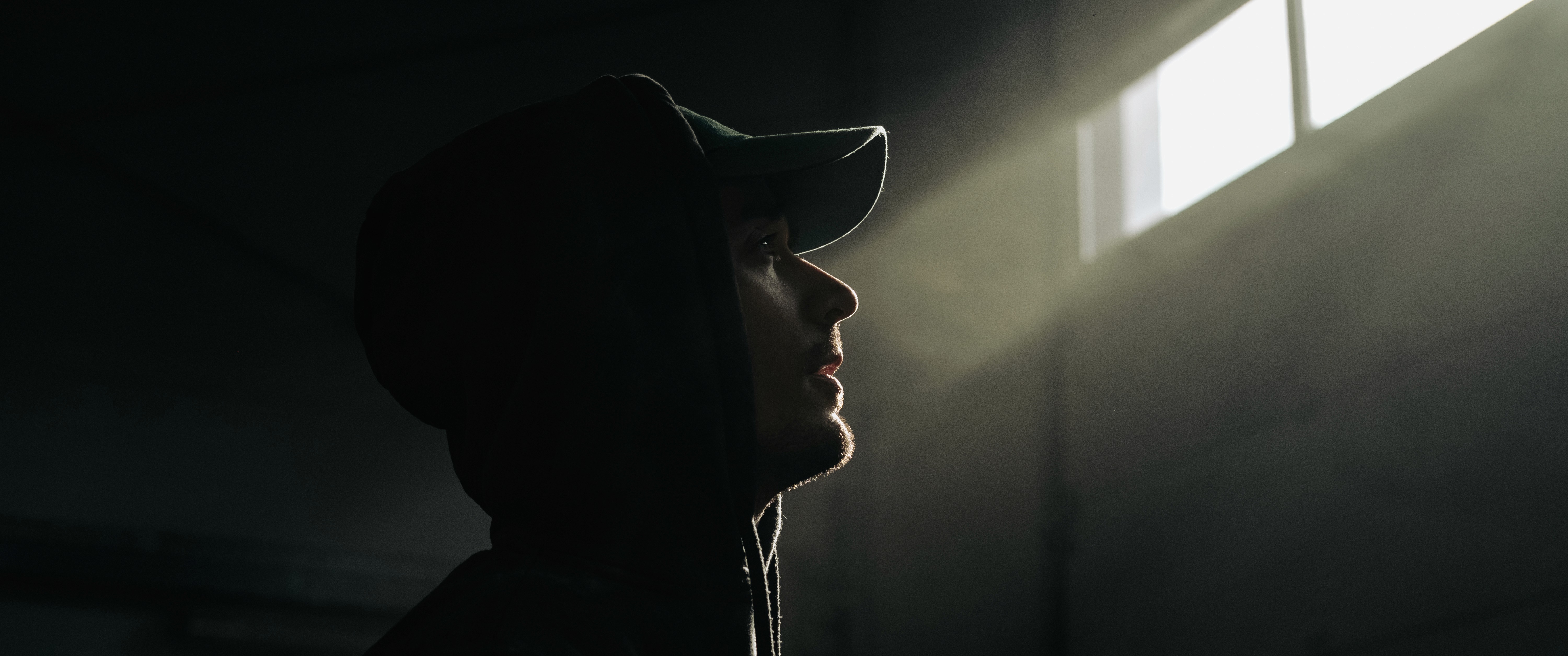 Person sitting on a ledge overlooking New York City skyline