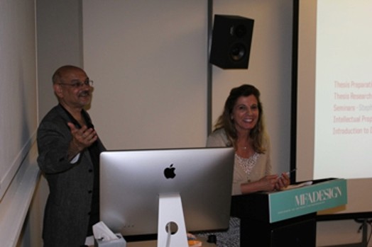 Image of two older people, a man and a woman giving a speech