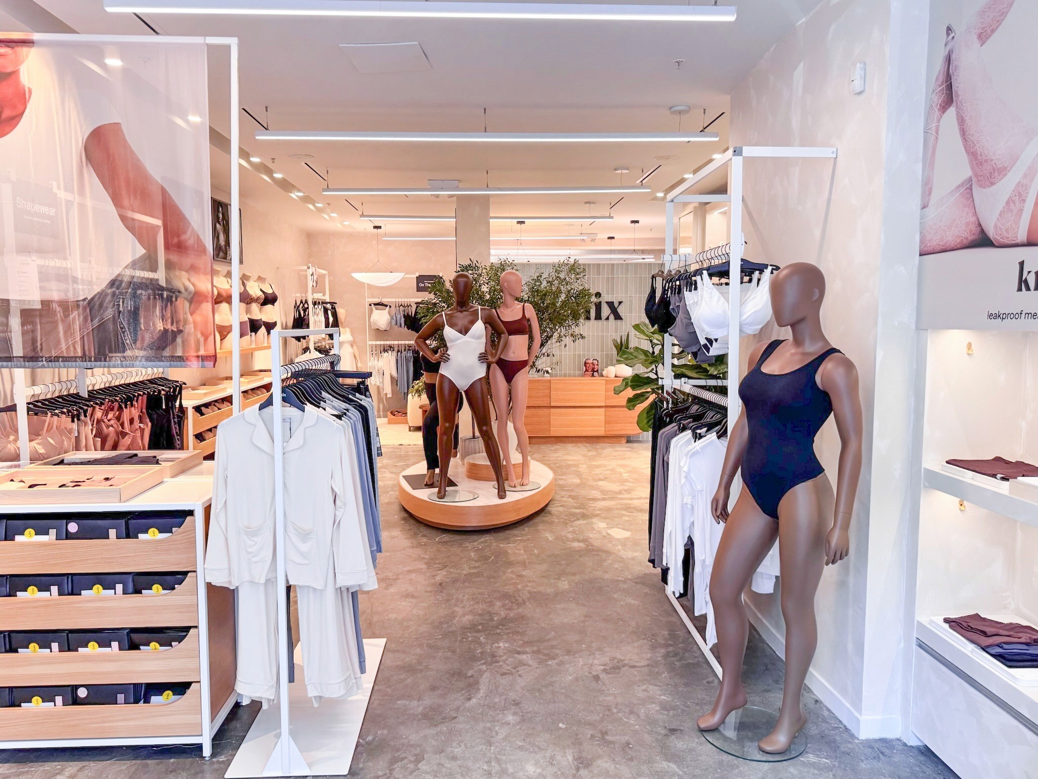 Knix store merchandising display with branded graphics and lingerie product presentation.