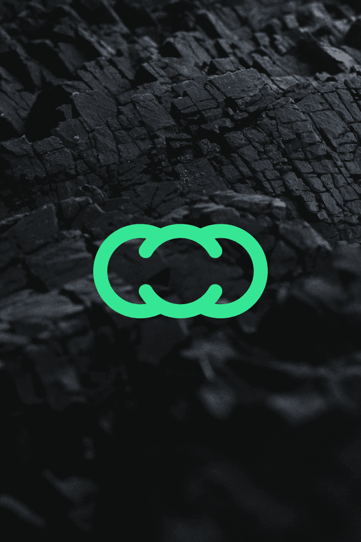 A smiling woman with her arms crossed, standing against a dark green background. She has long, dark hair.