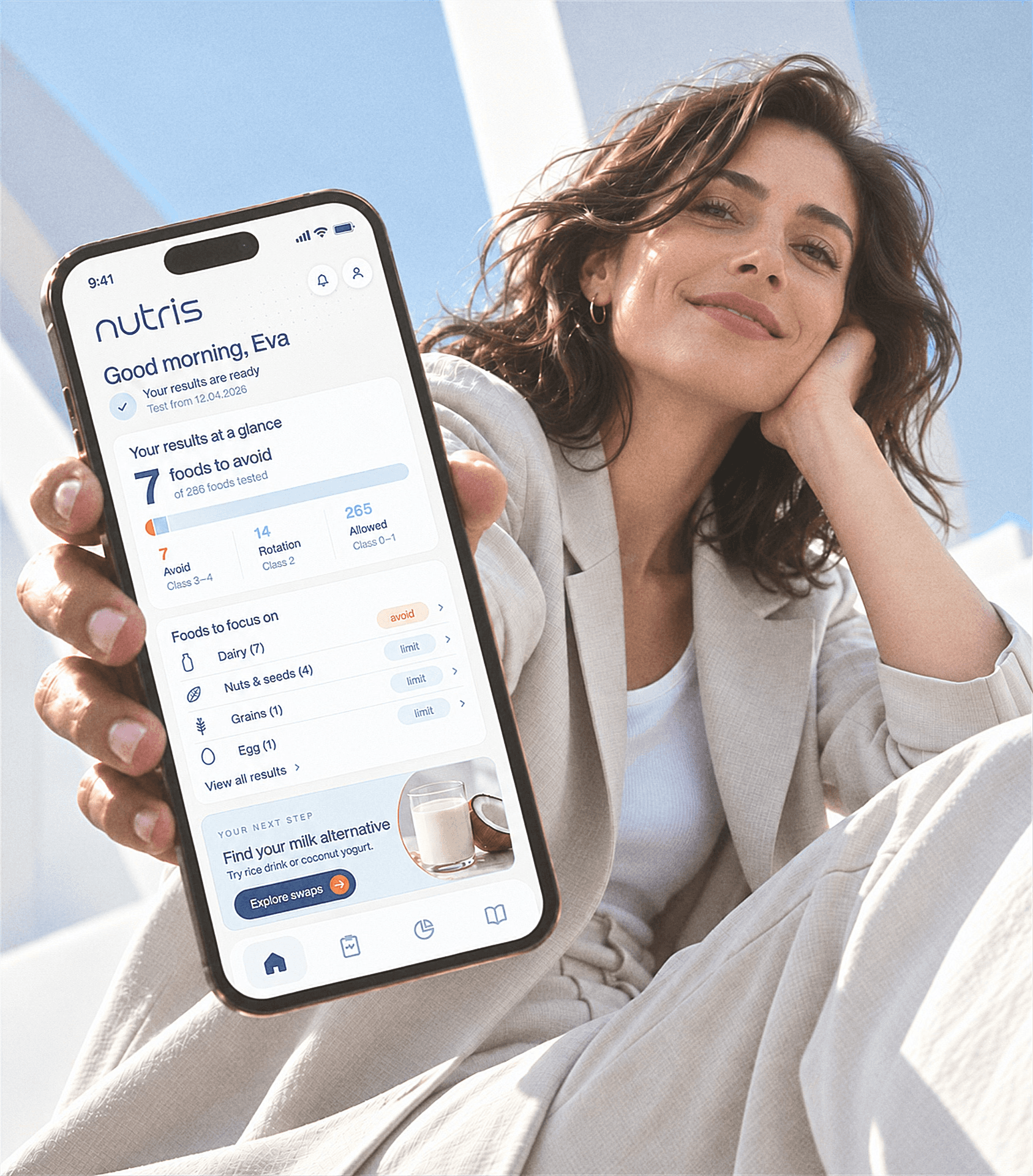 Woman holding a phone showing her Nutris results