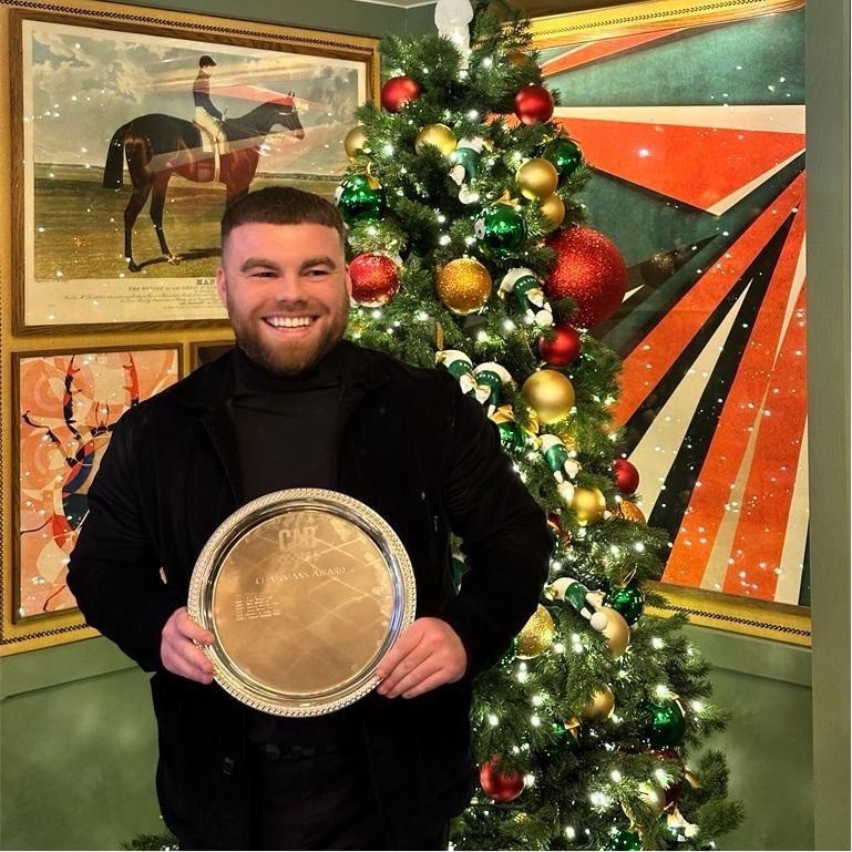 Connor Henman holding an industry award