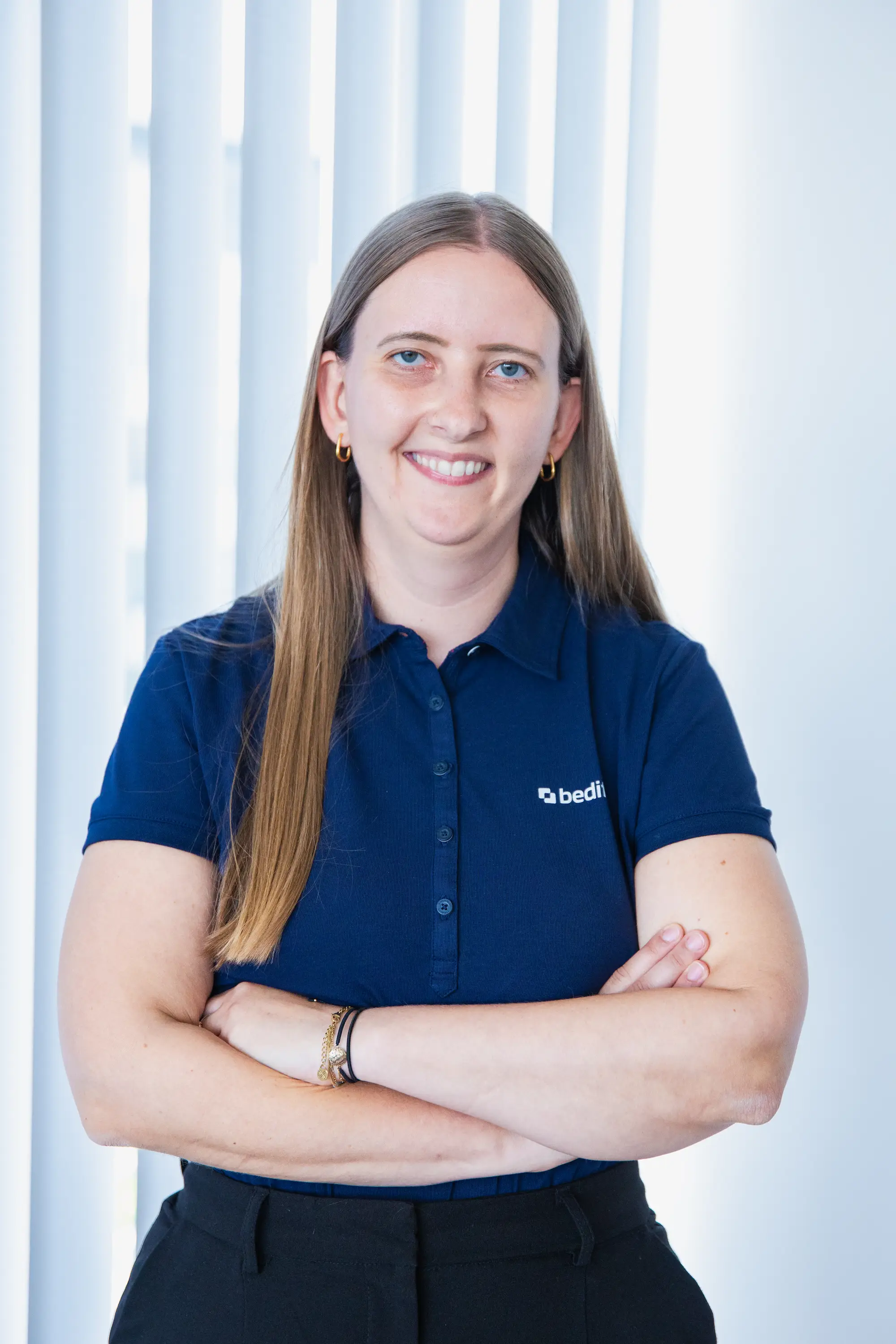 A woman in a dark blue Bedifol polo shirt.