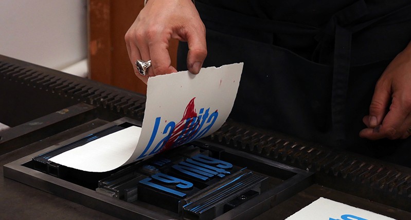 Cheking the imprint on a poster after a pressing process.