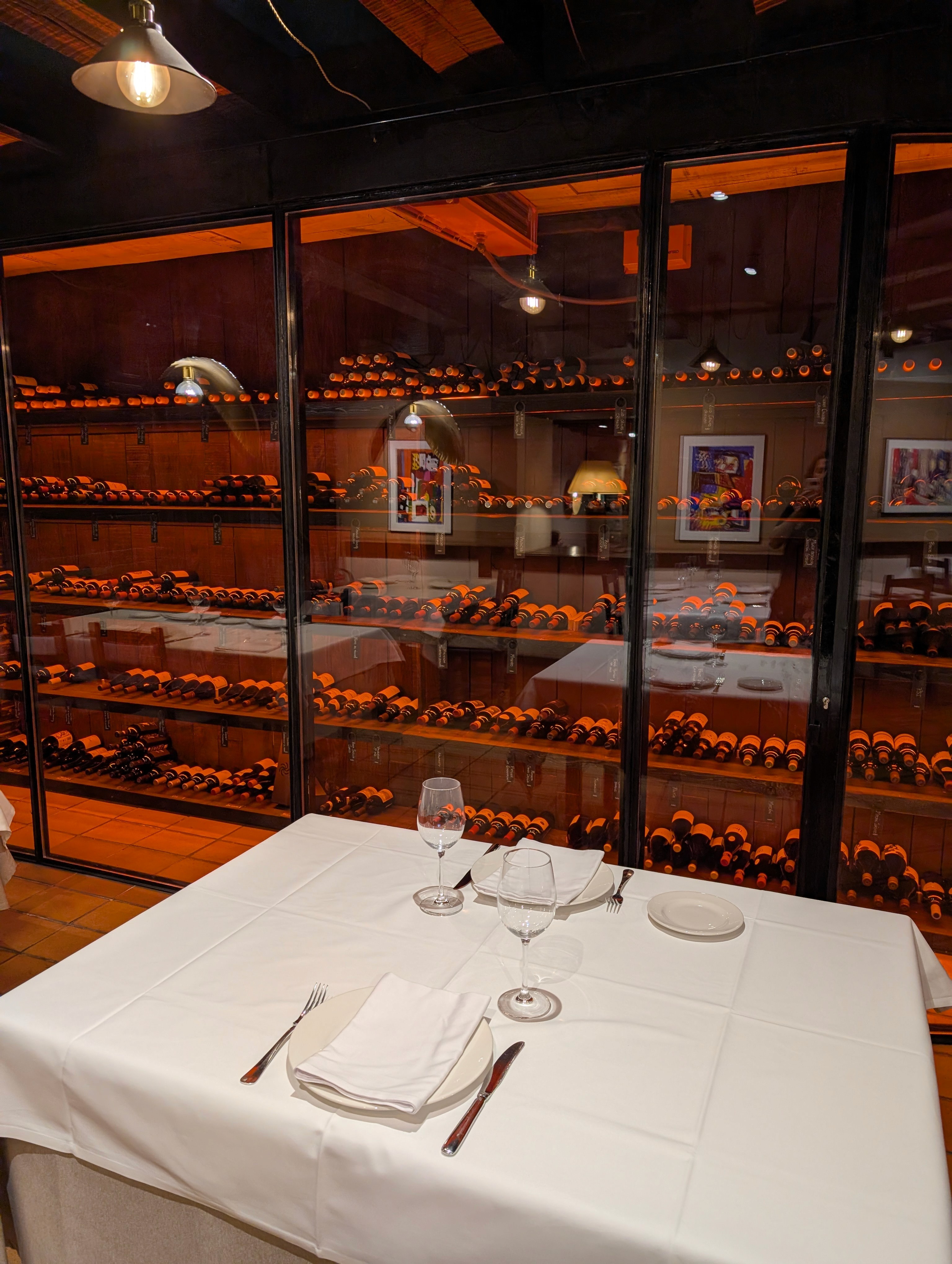 Vibrant pink and purple sunset colors reflected across serene ocean waves and sandy path.