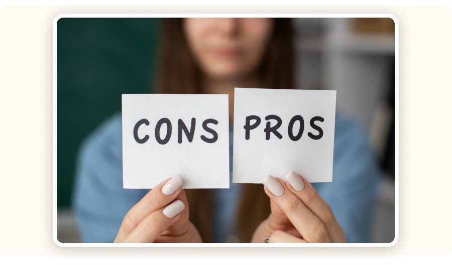 Person holding cards labeled pros and cons for comparison decision