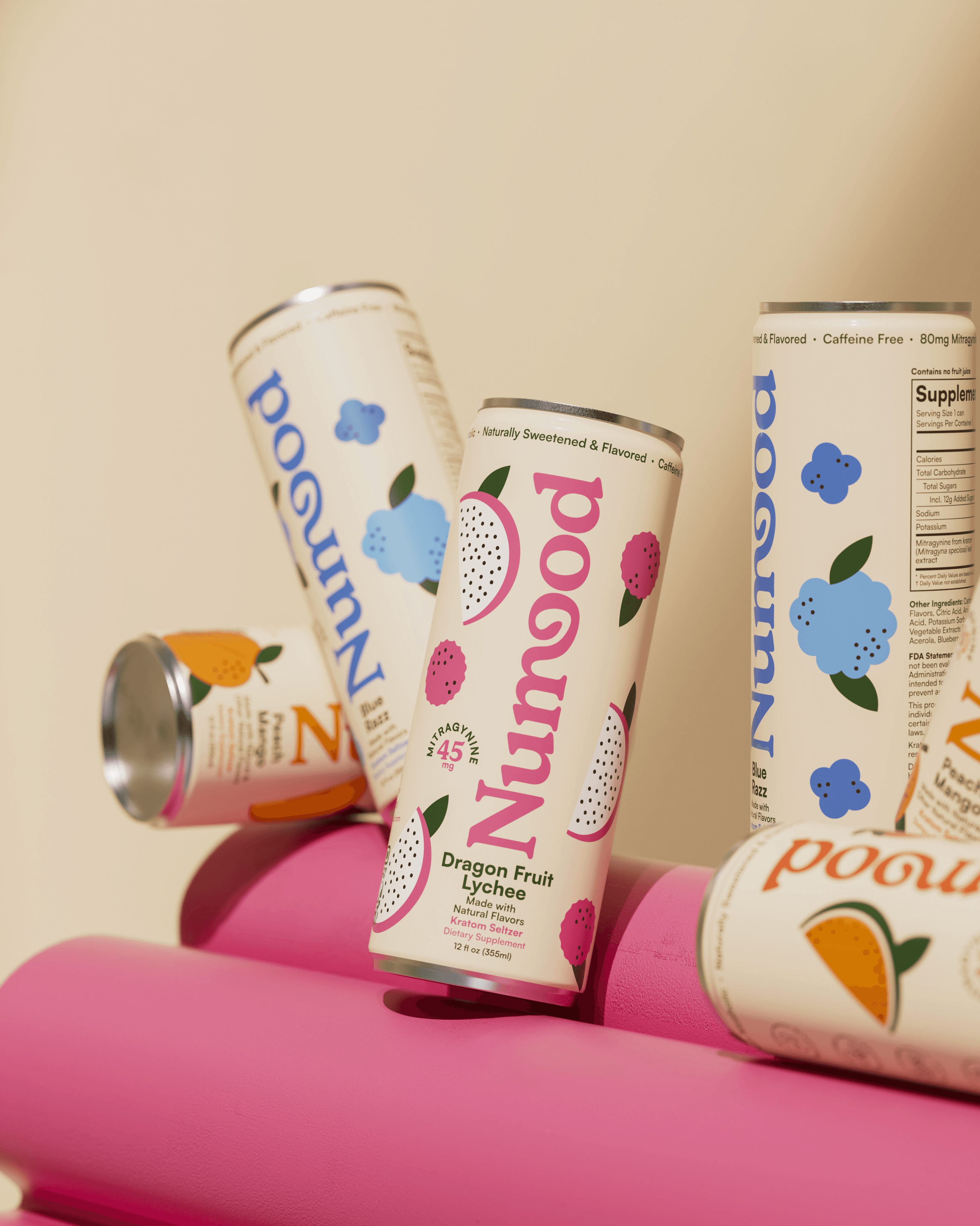 A smiling young man with crossed arms, wearing a plaid shirt and white t-shirt, poses against a dark background.