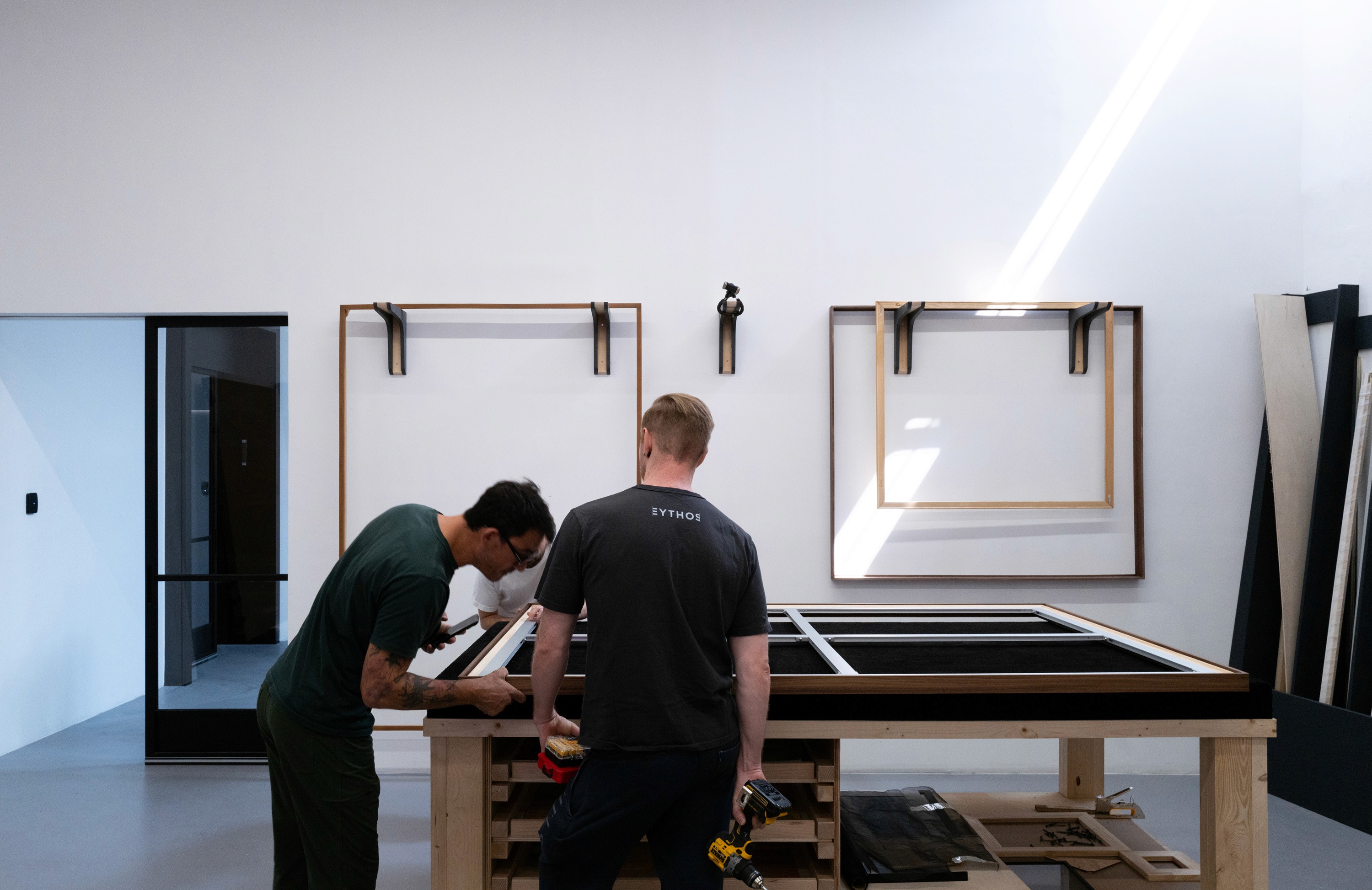 Two carpenters working in the Eythos framing studio