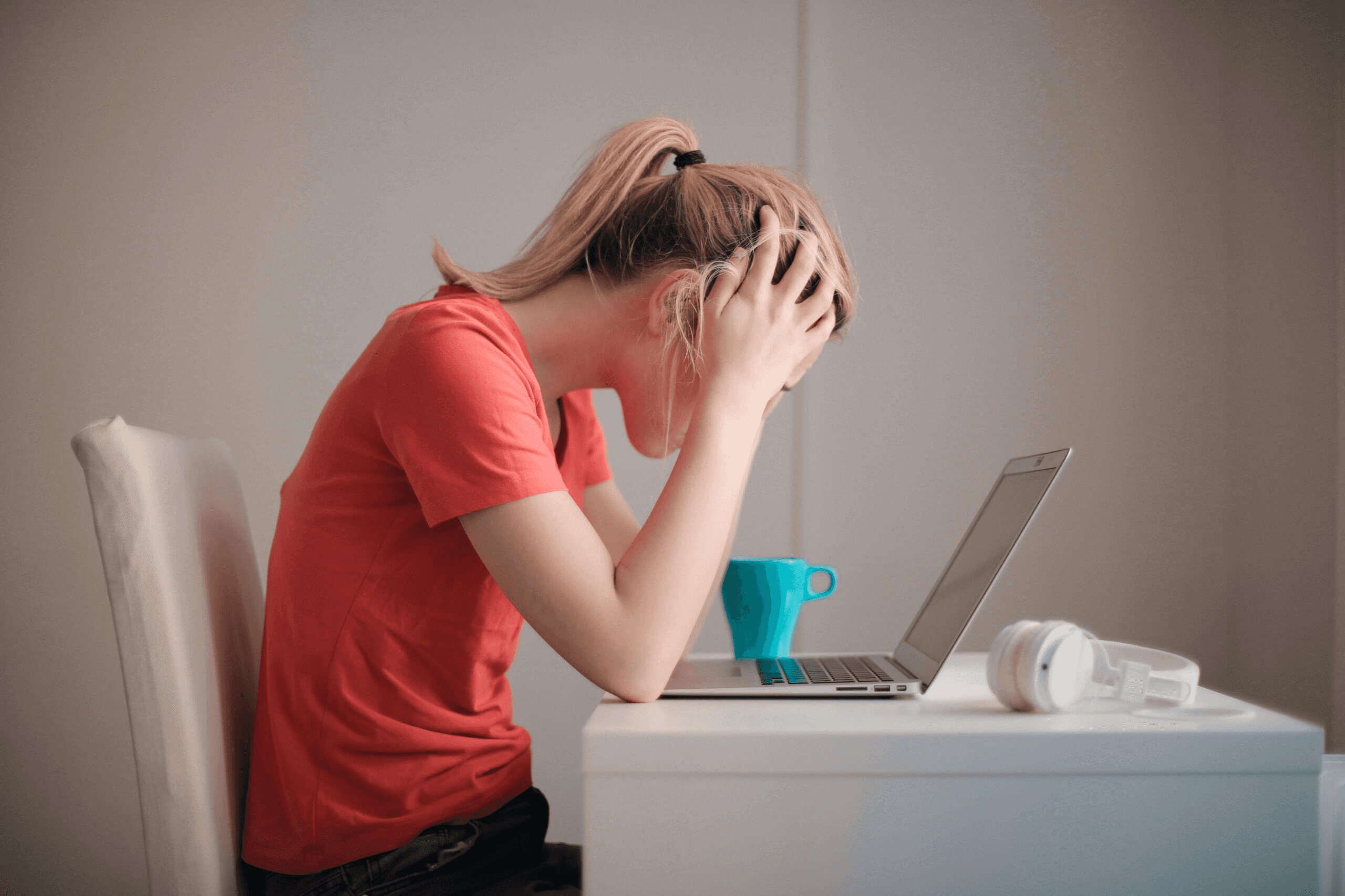 High school student reviewing a research timeline and notes at a desk, catching up on a delayed research project