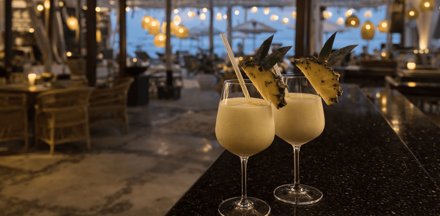 A close-up shot of a handcrafted welcome cocktail served at a Mediterranean hotel patio