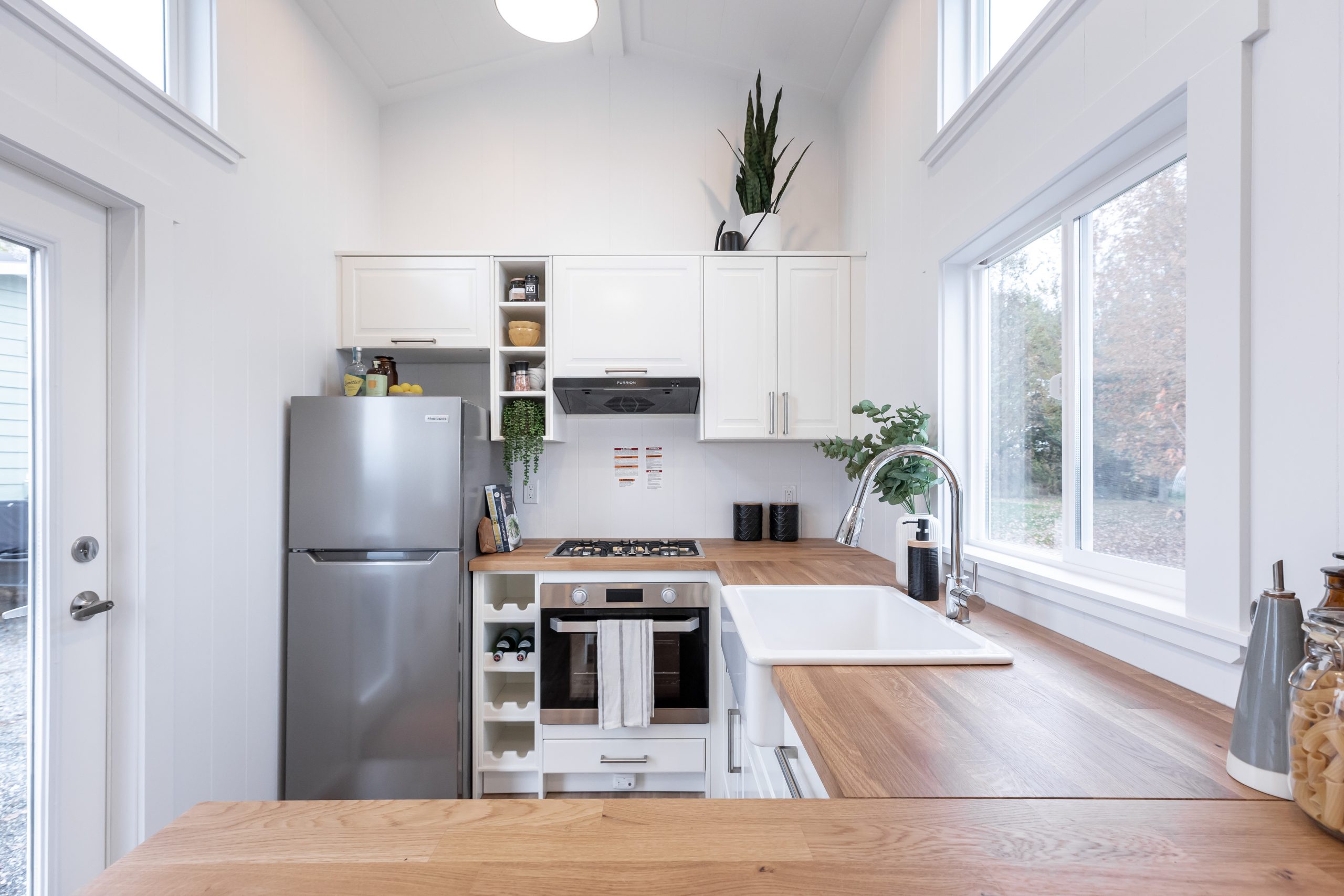 U-shape kitchen with plenty of storage - Mint Tiny House Company