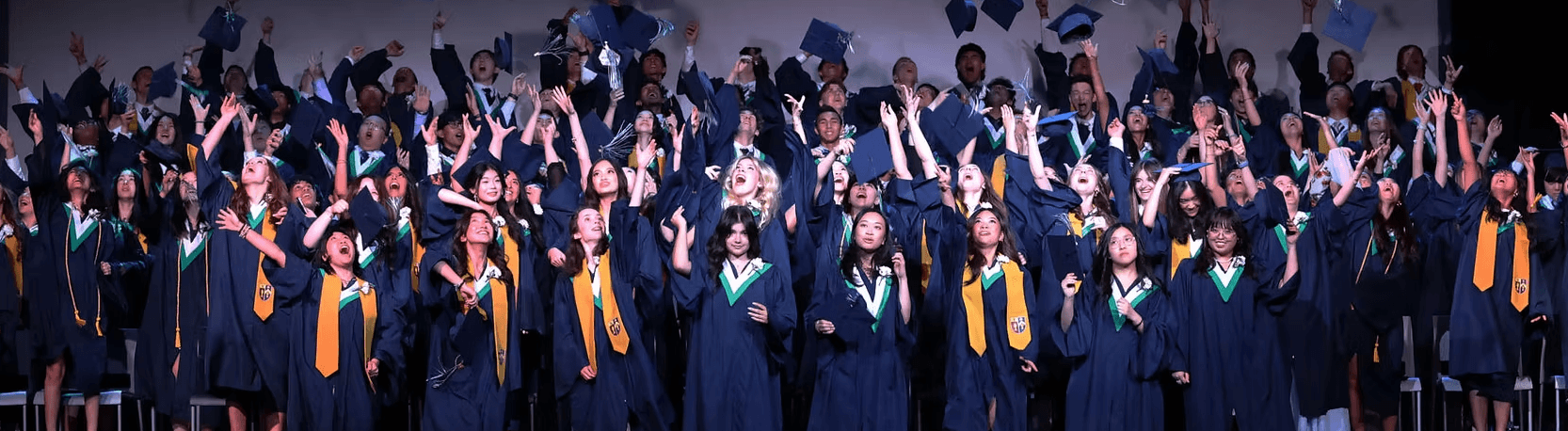 A multi-generational family poses for a group portrait outdoors.