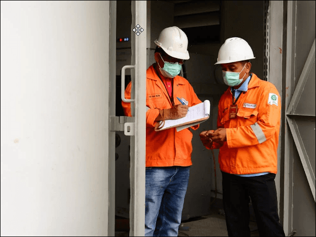 Construction Workers Reviewing Clipboard