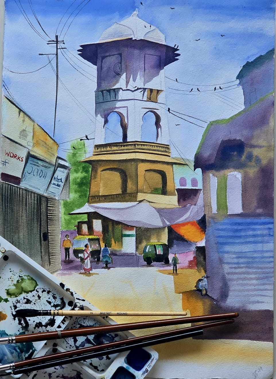 Colorful watercolor painting of an Indian street scene with buildings and a domed structure.