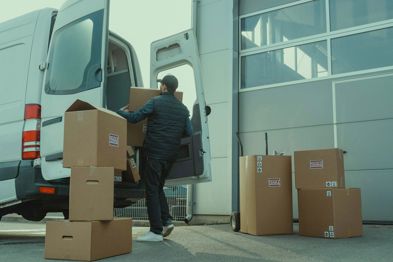 Man placing boxes inside truck.
