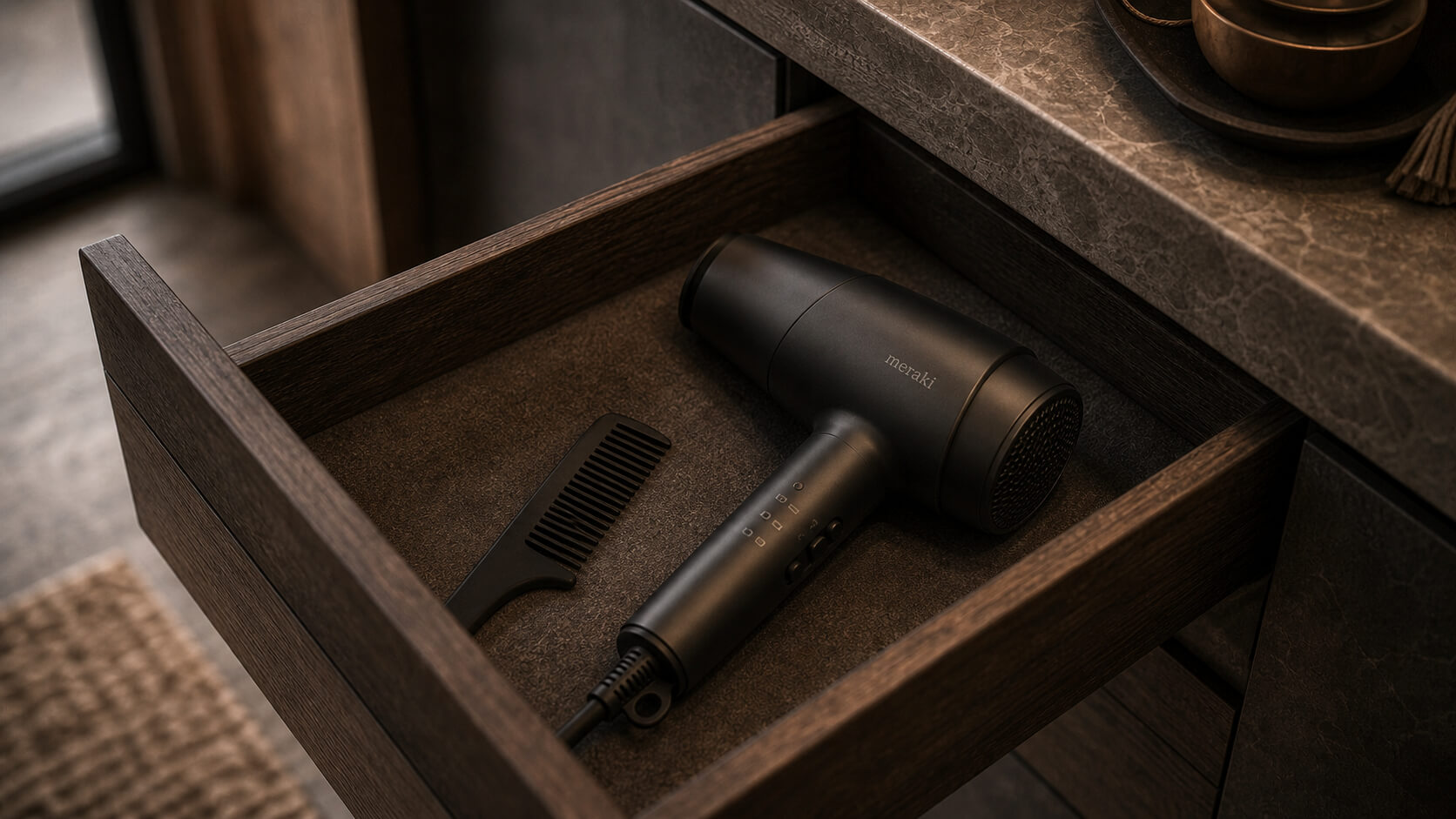 Hair dryer stored in an open wooden bathroom drawer
