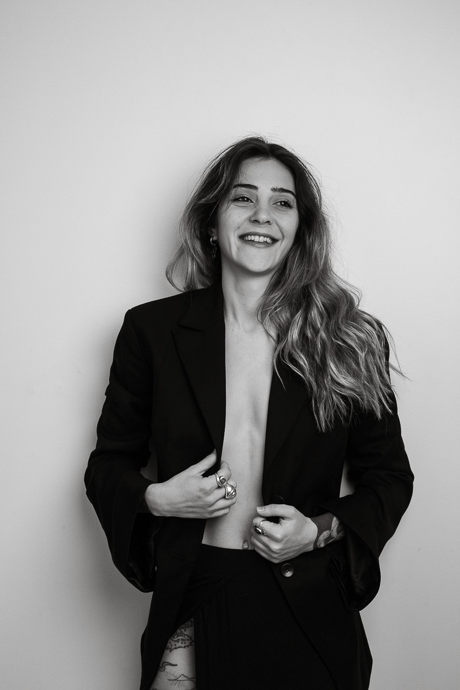 Potrait of a woman with curly hair smilling towards camera