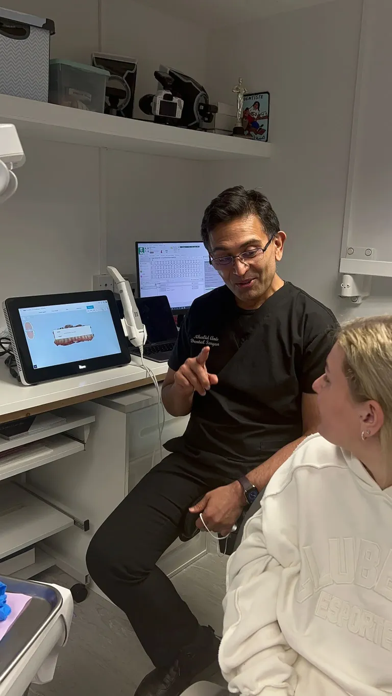 Dr Khalid speaking to a patient about their clear aligners treatment/ invisalign treatment.