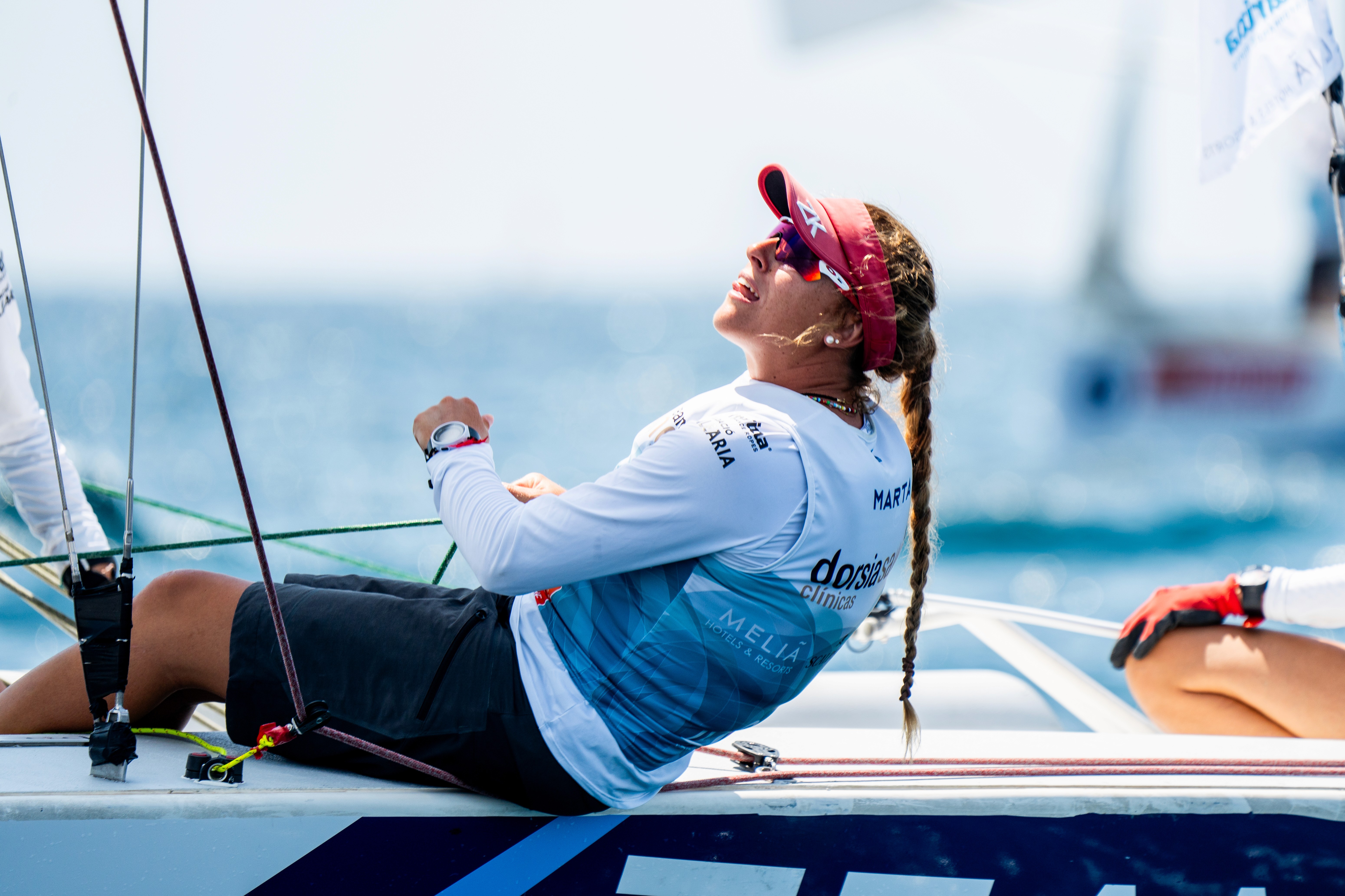 A woman with her eyes closed, wearing a helmet, appears to be in a moment of concentration or relaxation.
