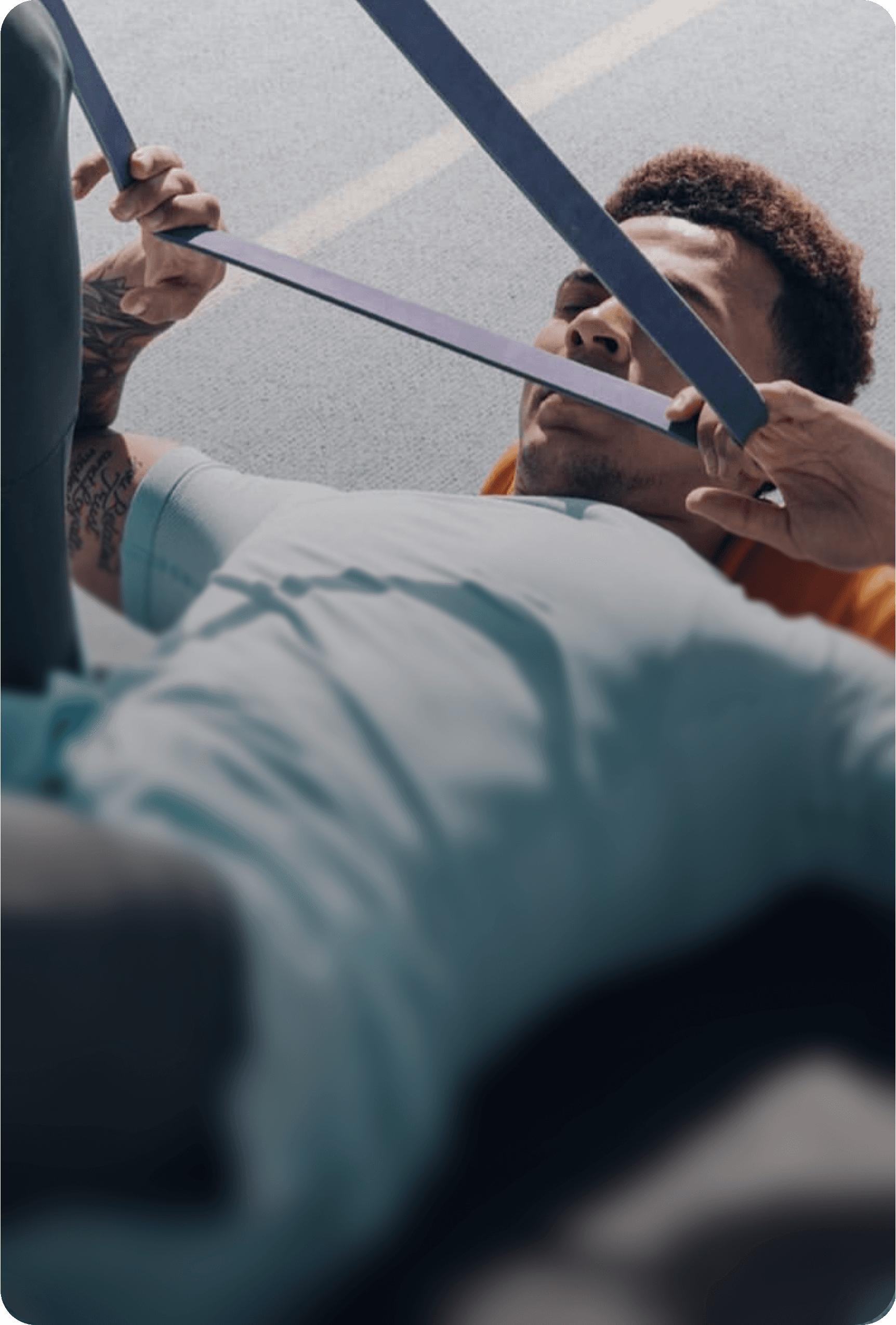 Man using resistance band for exercise, assisted by another person, improving flexibility.