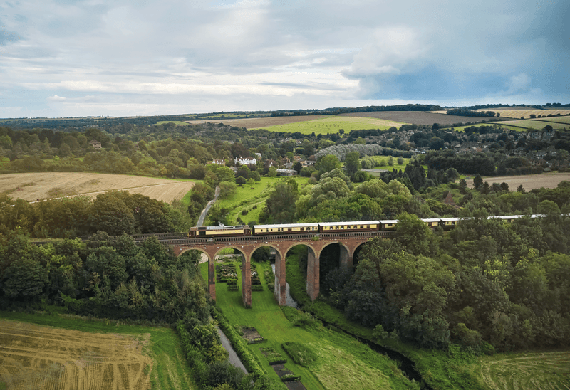 an aerial view of a baseball stadium with a city in the background