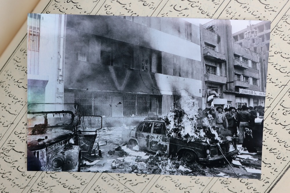 Bubjan with book and speaking to camera
