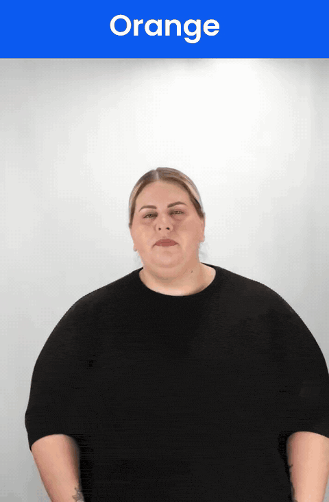 Animated GIF: a Deaf signer signs ORANGE in ASL, a fist squeezing in front of the mouth and chin.