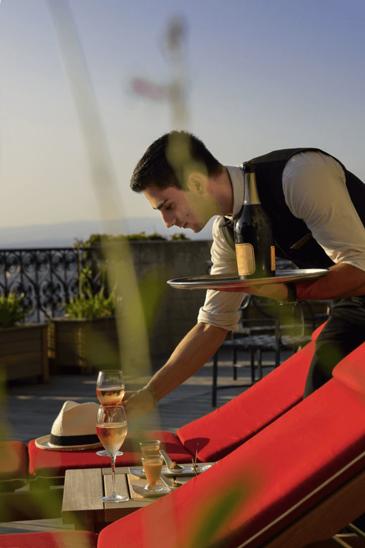 Team collaborating around a laptop during an SEO strategy meeting.