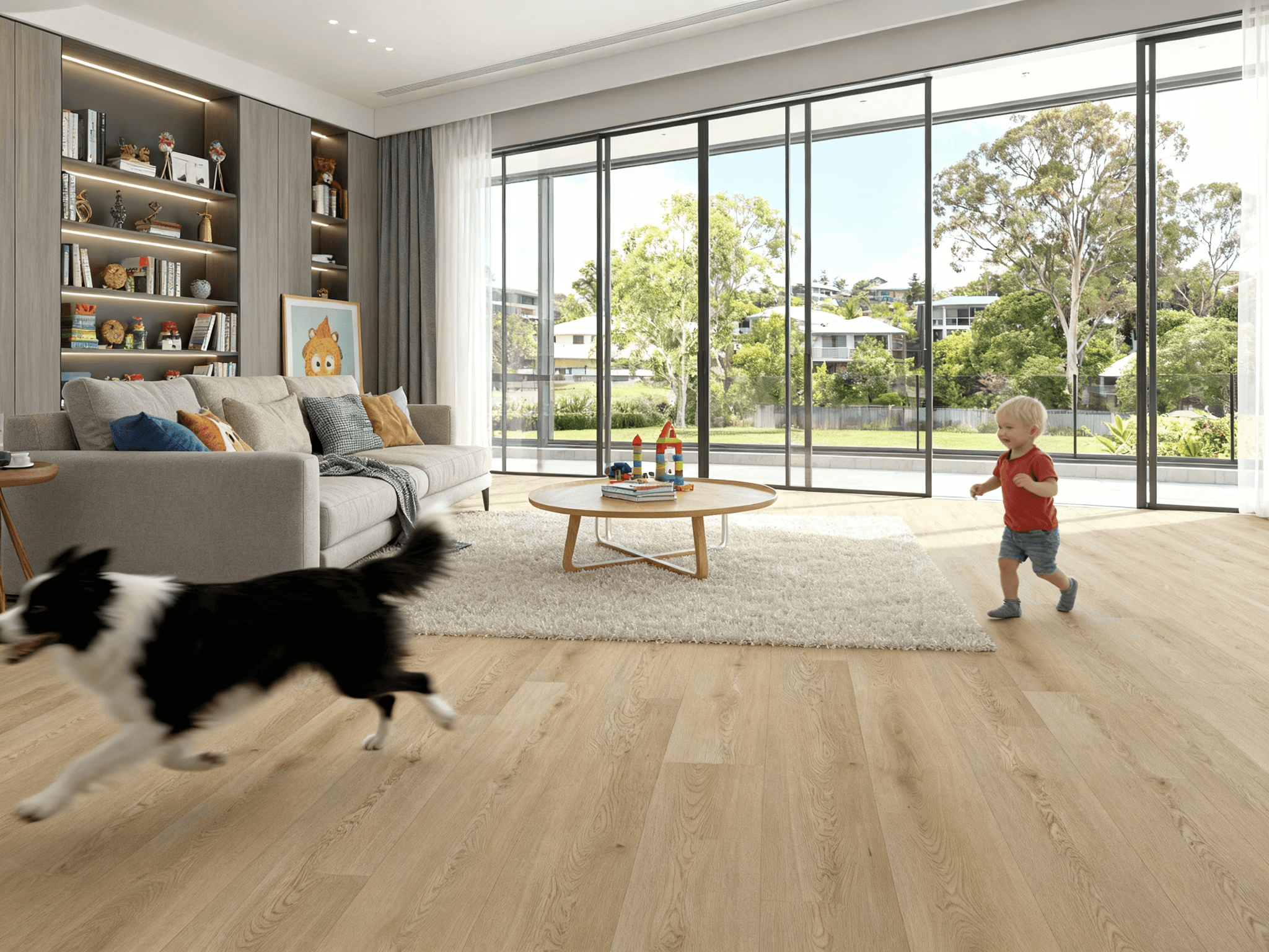 A toddler and dog playing in a bright modern living room with light oak timber flooring, highlighting LUXO Floors’ scratch-resistant and family-friendly design ideal for active Australian homes.