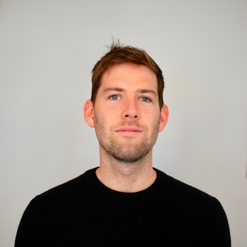 potrait of a man facing camera wearing a black jumper